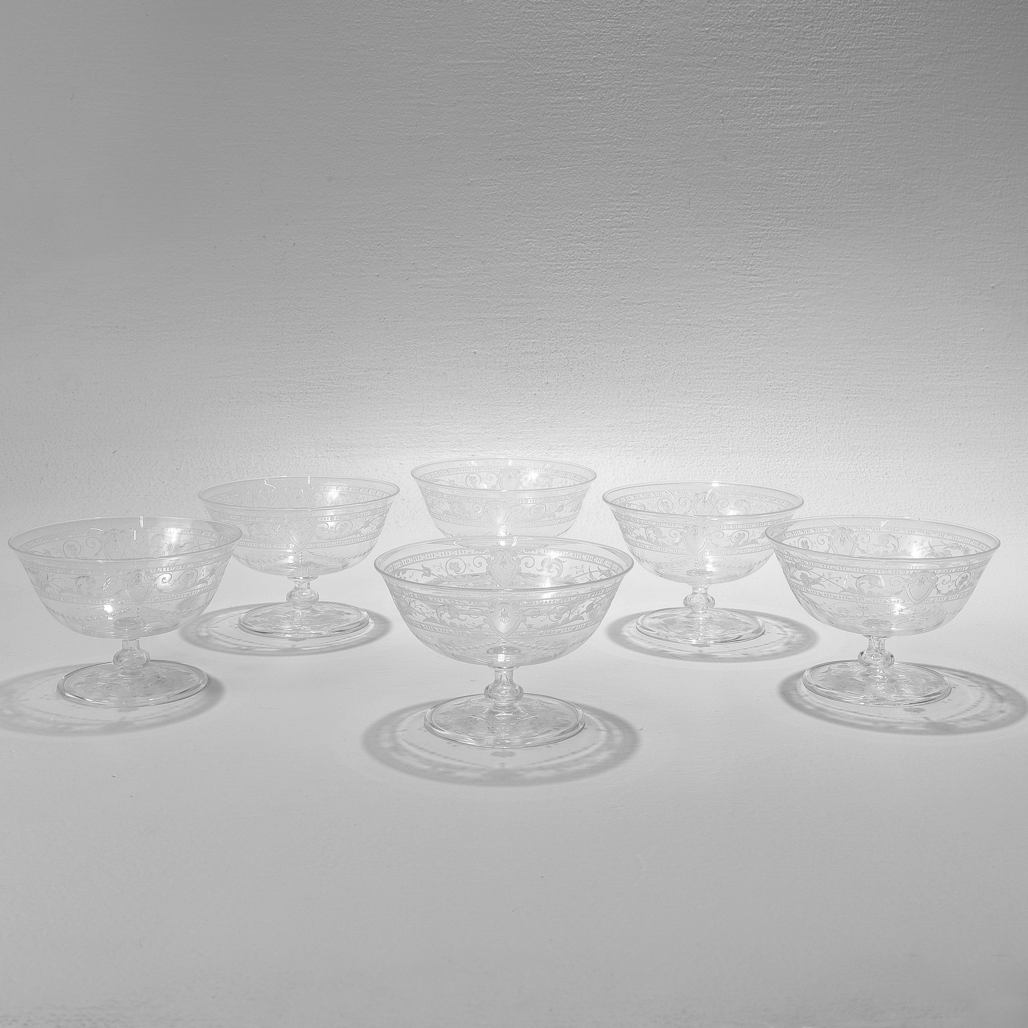 A fine set of 6 antique etched and engraved glass sherbert bowls.

Attributed to Stevens & Williams or Webb.

In the style of William Fritsche or William Kny.

With engraved & etched designs trelliswork, flowers, and shield devices.

Simply a