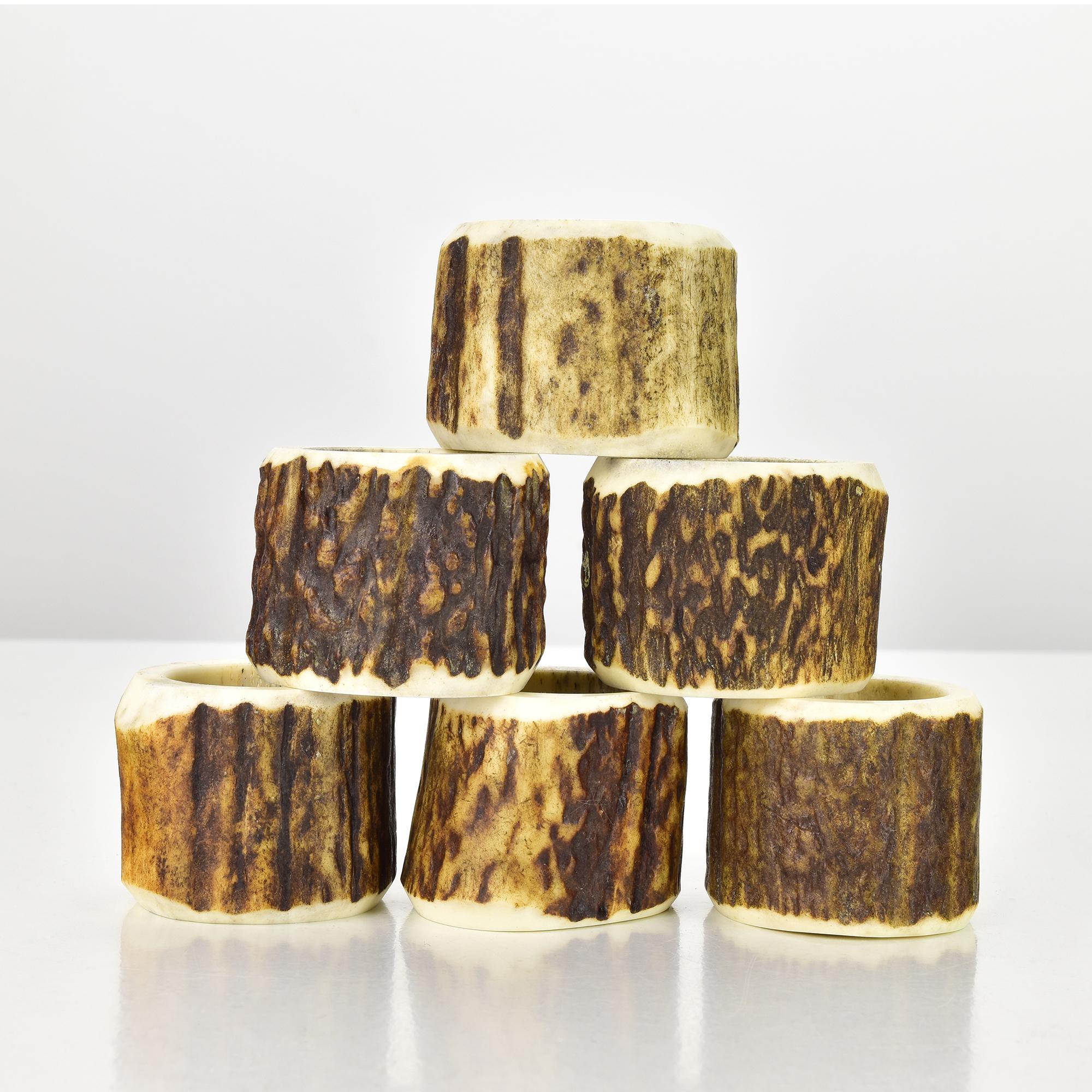 This authentic 1960s set of six napkin rings is handcrafted from real deer antler, showcasing the natural textures, hues, and organic charm of the material. Each ring is unique in its grain and patina, featuring a smooth interior and a naturally