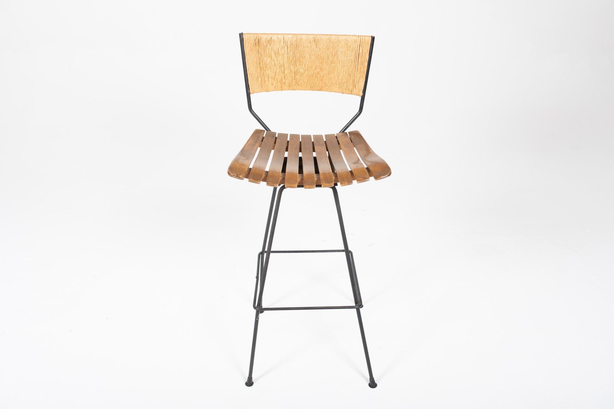 20th Century Set of 6 Arthur Umanoff Swivel Seat Bar Stools in Slatted Wood, Raffia, & Iron For Sale
