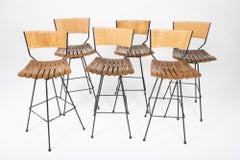 Set of 6 Arthur Umanoff Swivel Seat Bar Stools in Slatted Wood, Raffia, & Iron