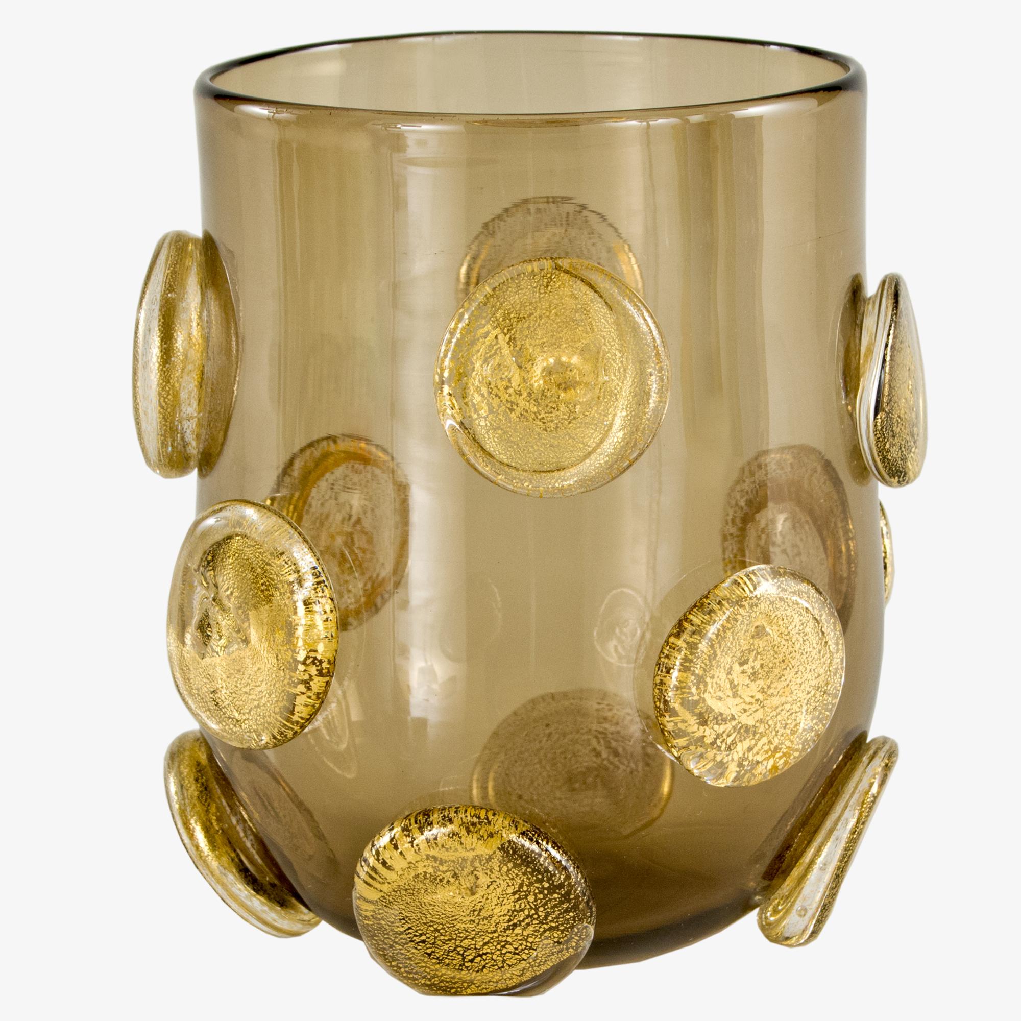 These artistic glasses are handmade by the master artisan in smoky color with golden leaf round applications.
Every piece differs one from the other.

Precious pieces that can enrich every table.

The handcrafted soul of our lighting products is
