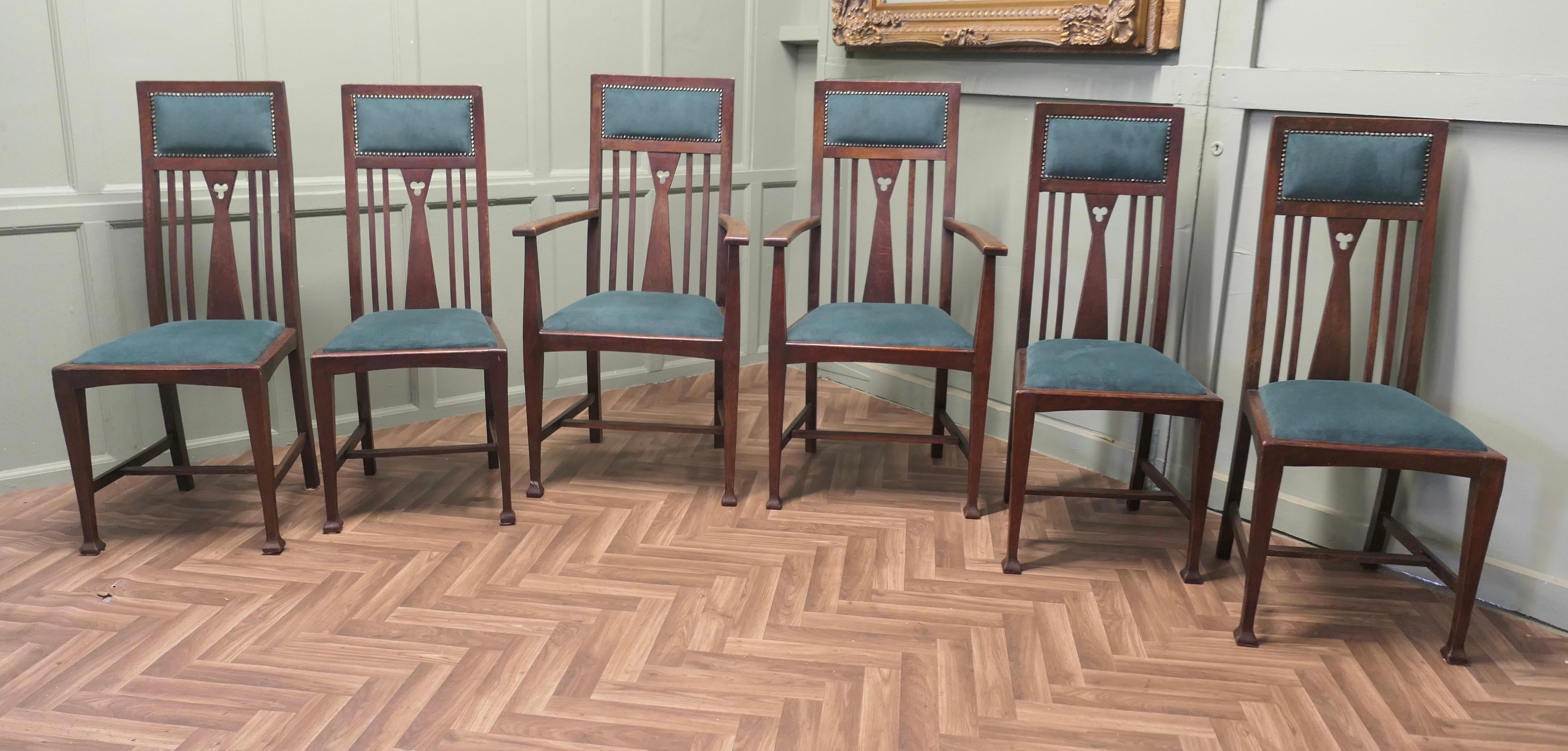 Set of 6 Arts and Crafts Dining Chairs 

This is a very handsome set of Dining Chairs, 4 single dining chairs and two carvers
The stylish Walnut frames have square tapering legs and the backs have flat shaped slats with hand carving detail to the