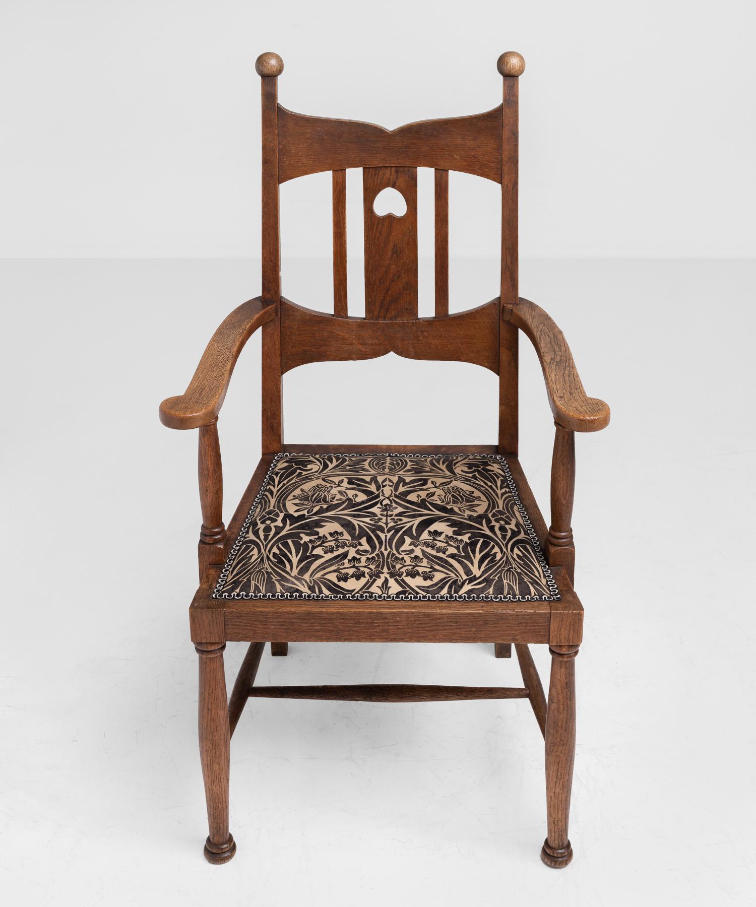 Set of (6) Arts & Crafts oak dining chairs, England, circa 1900.

Highback oak dining chairs in the manner of Liberty & Co. with upholstered seat in the style of William Morris.

Measures: 18.5