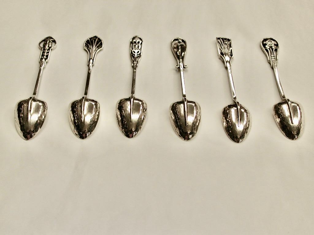 Set of 6 Australian silver coffee spoons by James Linton, each terminal having a different flower head with the bowls having a hammered/planished finish.
The Linton's silver workshop in Perth was established early in the 20th century by James
