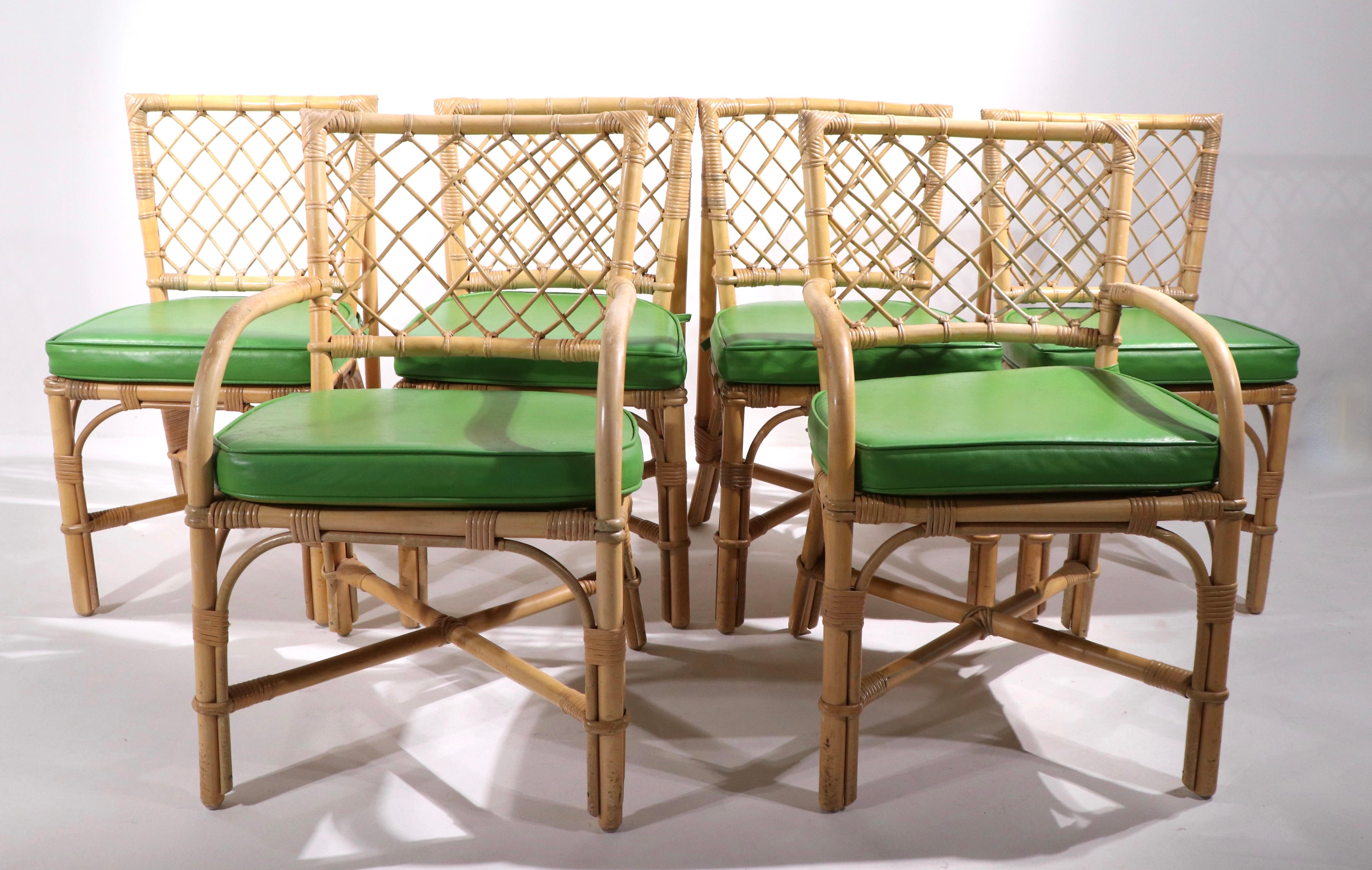 Well constructed set of bamboo dining chairs having lattice work backs, upholstered pad seats. Set consists of 4 arm chairs, and 2 arm, or captains chairs. 
 Dimensions for Arm Chairs
Total H 33 in. x Arm H 24.5 in. x Seat H 18.5 in. x W 20 in. x