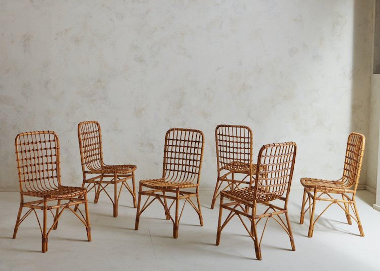 A set of 6 Mid-Century Italian dining chairs constructed with bamboo and rattan. These elegant chairs feature curved bamboo frames with widely woven seats and backs. We love the subtle color variations, warmth and durability of these natural
