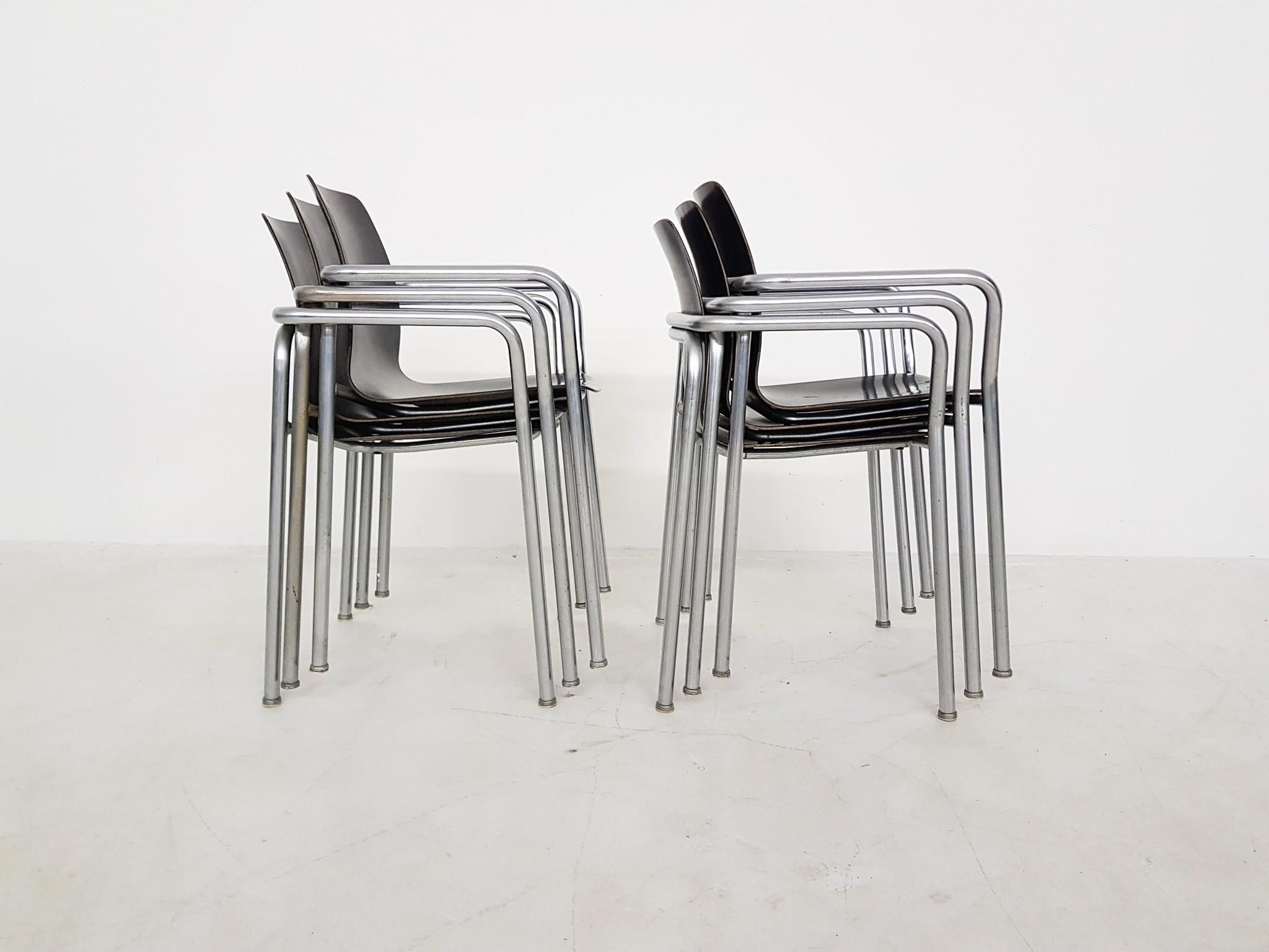 Tubular chrome frame and black plywood seating and back. Can easily be stacked
Some rust on the frame. One has some scratches on the seating.