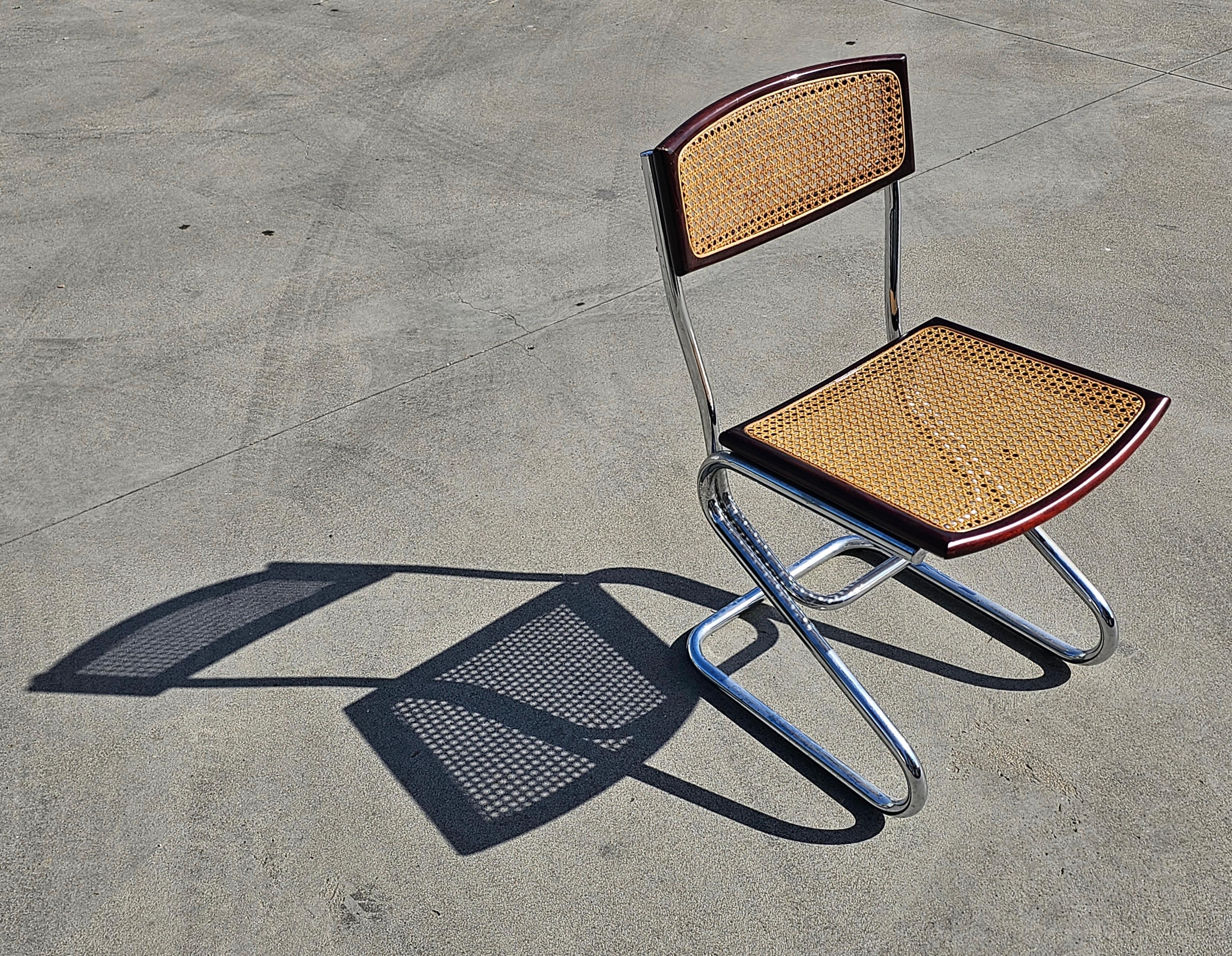In this listing you will find a set of 6 Bauhaus style dining chairs done in style of Cesca chairs designed by Marcel Breuer. They feature tubular frames with seats and backrests done in beech wood and cane. The cane on the seats was recently