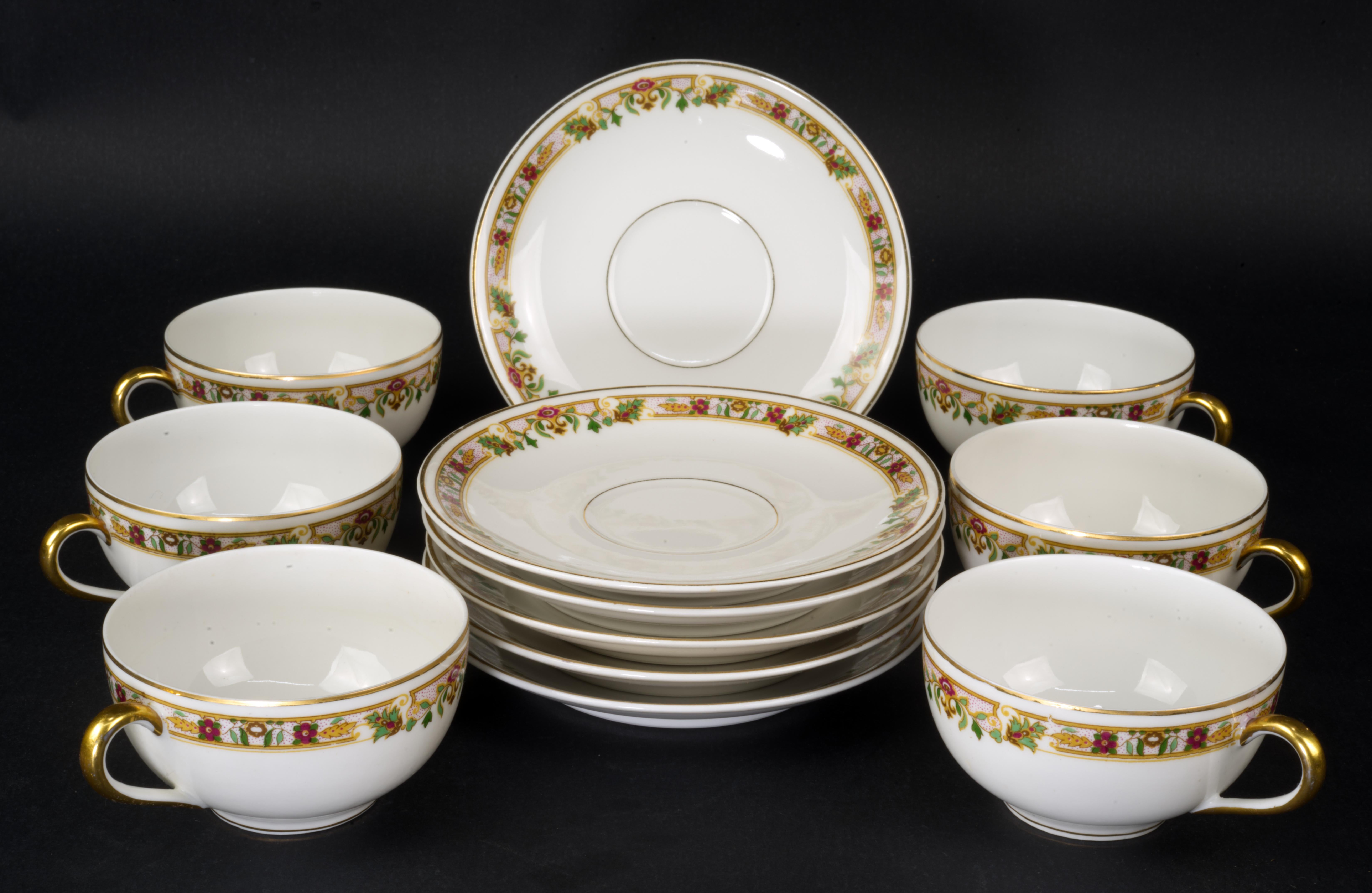  El juego de 6 tazas y 6 platillos fue fabricado en porcelana fina semitransparente en Limoges, Francia, por L. Bernardaud & Cie. Está decorada con un borde floral de estilo Art Déco en colores tostado, rojo y verde, y adornos y detalles