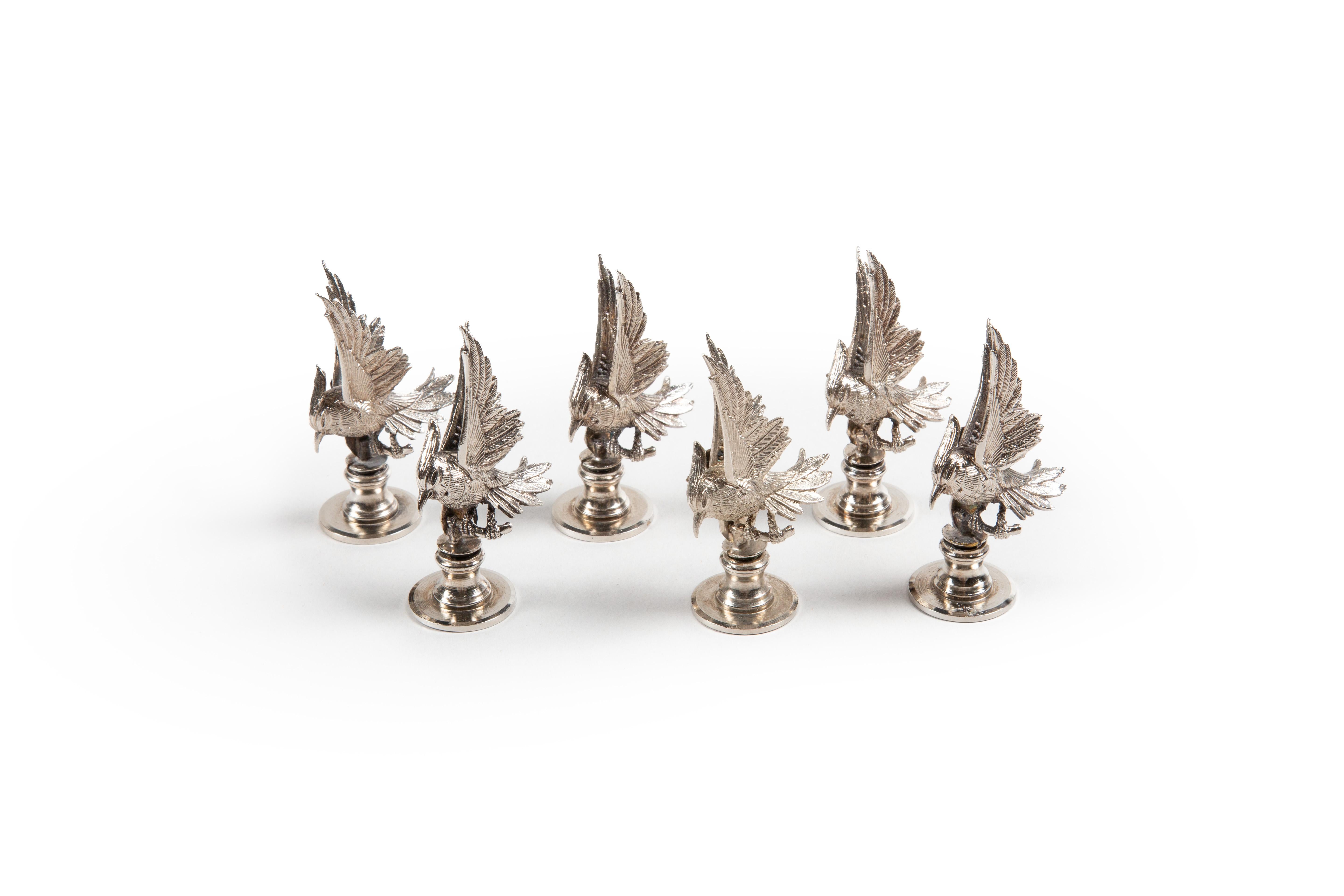 Add elegance to your table setting with this set of six silver-plated bird in flight place card holders. Each holder captures the beauty of a bird in motion and is perfect for showcasing guests' names or special messages. These holders are both