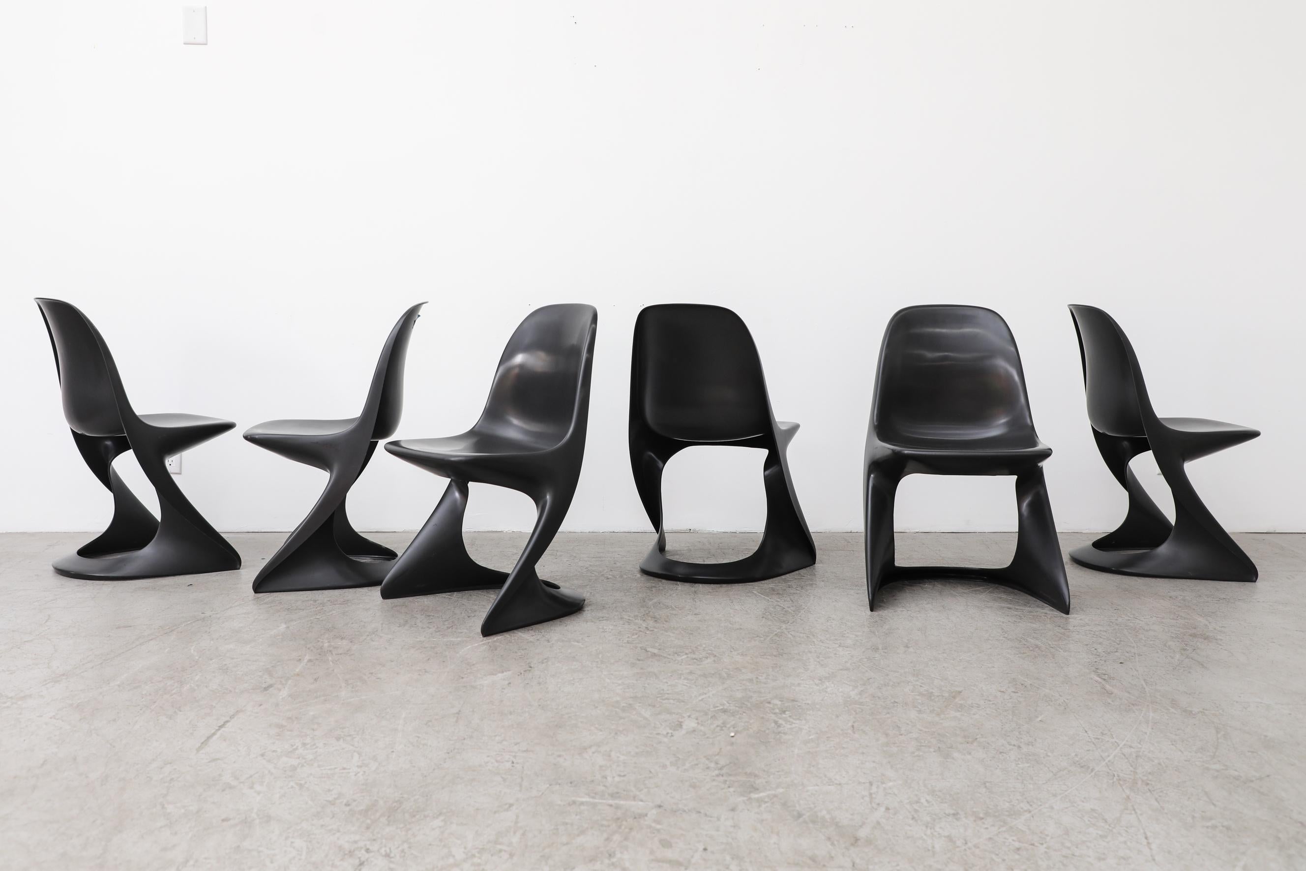 Set of six 1970's black plastic stacking Casalino chairs by Alexander Begge. In original condition with visible wear, including some scratching. Wear is consistent with their age and use. Other colors also available, listed separately.