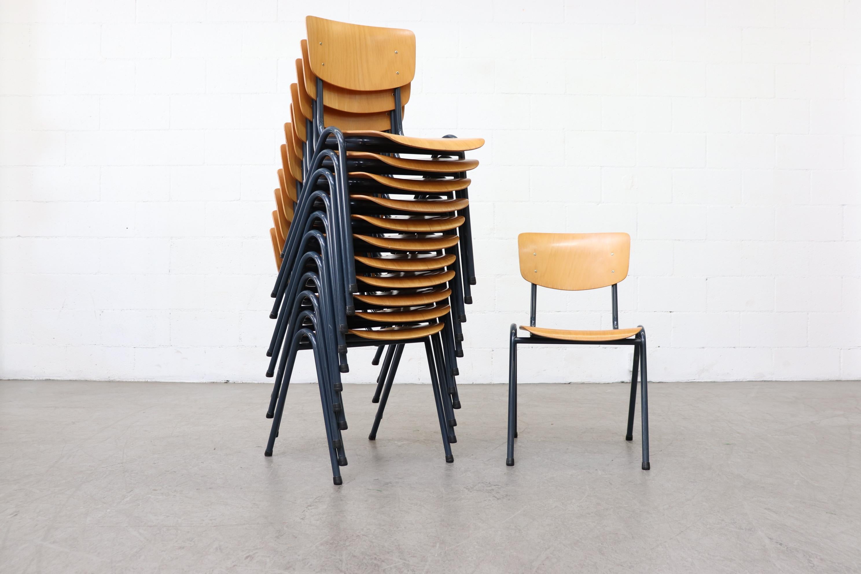 Set of 6 blonde plywood industrial stacking chairs with blue-grey enameled metal tubular frame. In original condition with normal wear including minimal cracking and enamel loss. All wear is consistent with age and use. Set price. Multiple sets