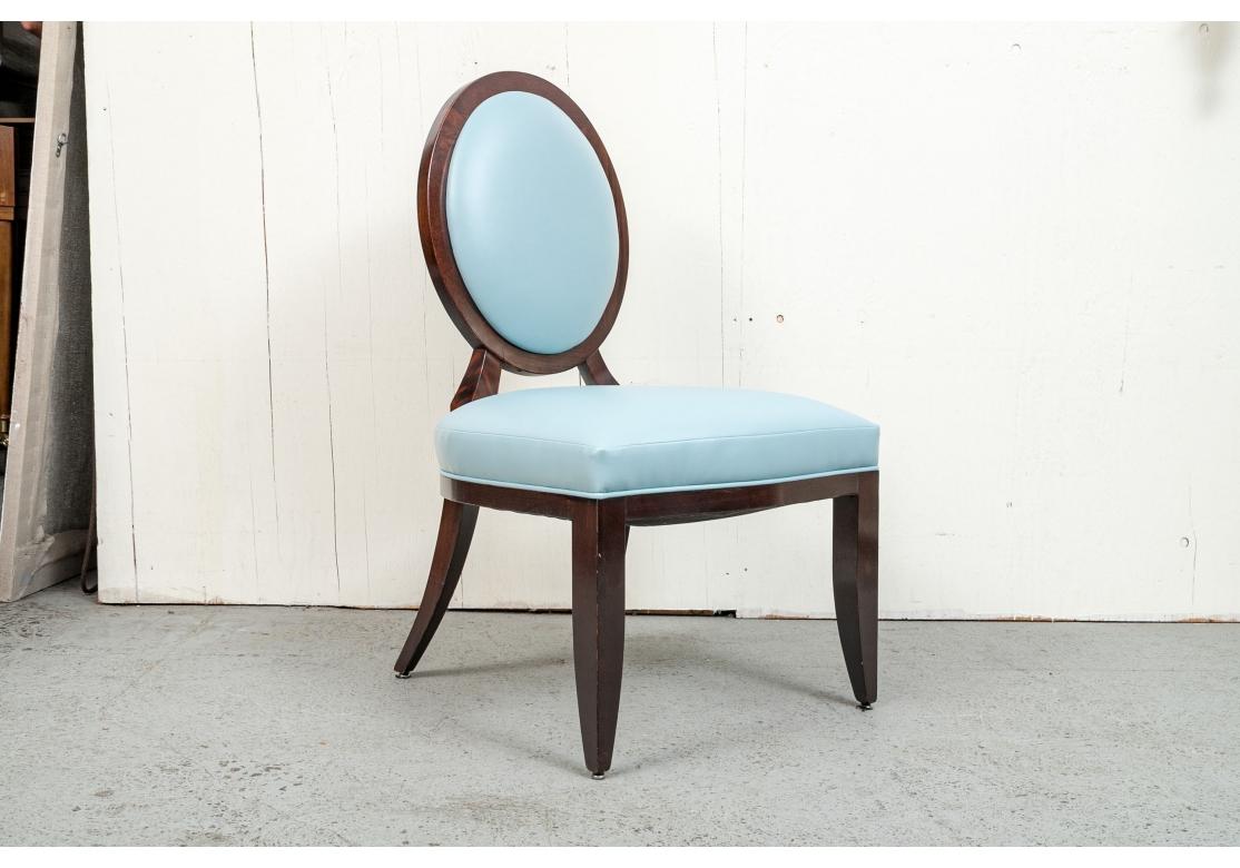 Set of 6 fine dining chairs designed by Barbara Barry for Baker. The chairs covered in a soft pallet of Tiffany blue leather with a contrasting voided velvet back. The chairs with balloon back, wide seats, X-form fretwork on back, resting on