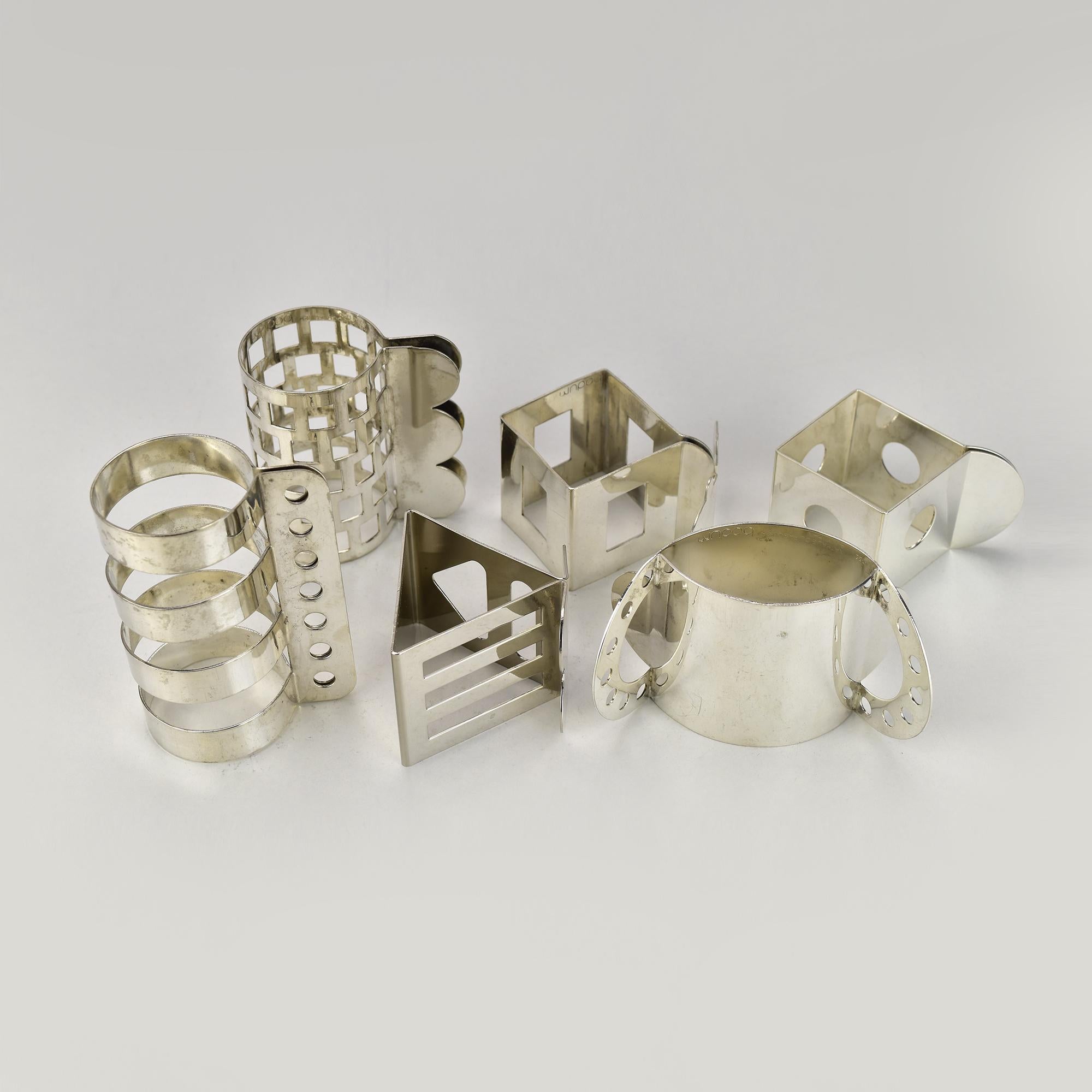 This striking set of six Bodum postmodern napkin rings was designed in the 1980s by Jumi Chan and Nathalie Du Pasquier, a founding member of the Memphis Group. Each ring showcases a different geometric silhouette, reflecting the bold, sculptural