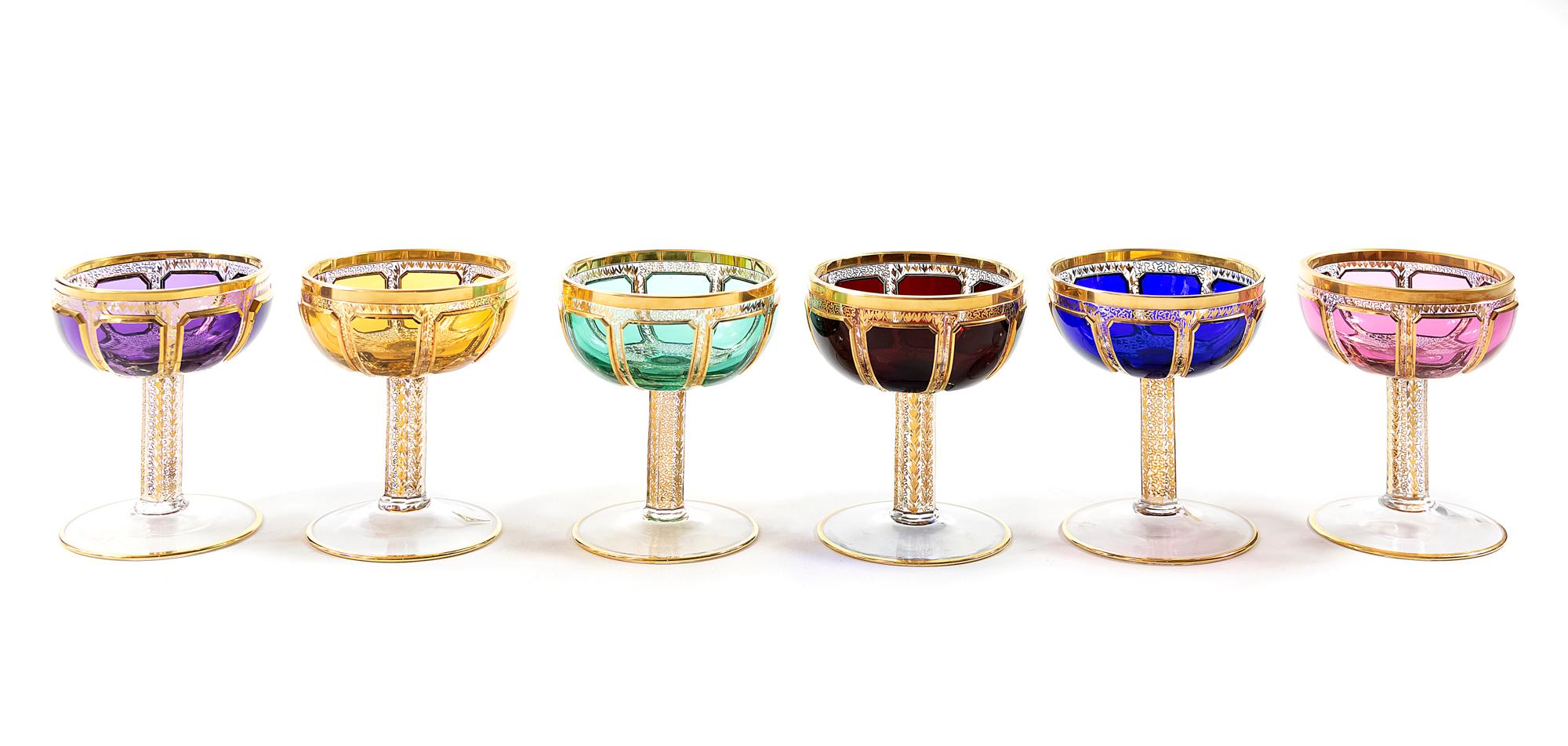 The set of 6 pcs. Bohemian champagne glasses are heavy and solid.
The base of each glass is transparent and decorated with different color glass, gilt trims and gold pattern through the glass.
Very good condition.

  