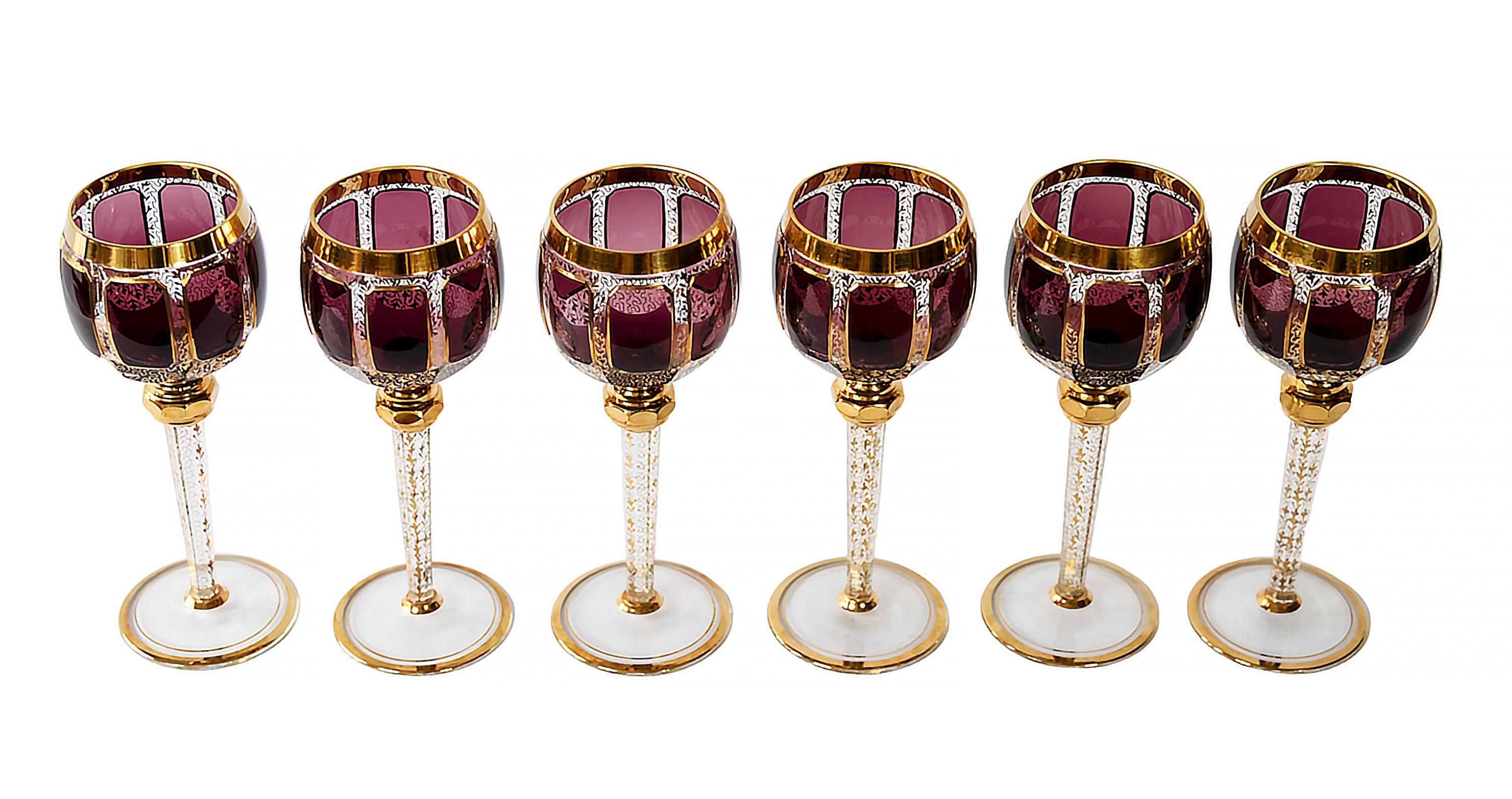 The set of 6 pcs. Bohemian wine glasses.
Each glass is transparent and decorated with dark amethyst/burgundy color glass, gilt trims and gold pattern through the glass.
Very good/excellent vintage condition.

