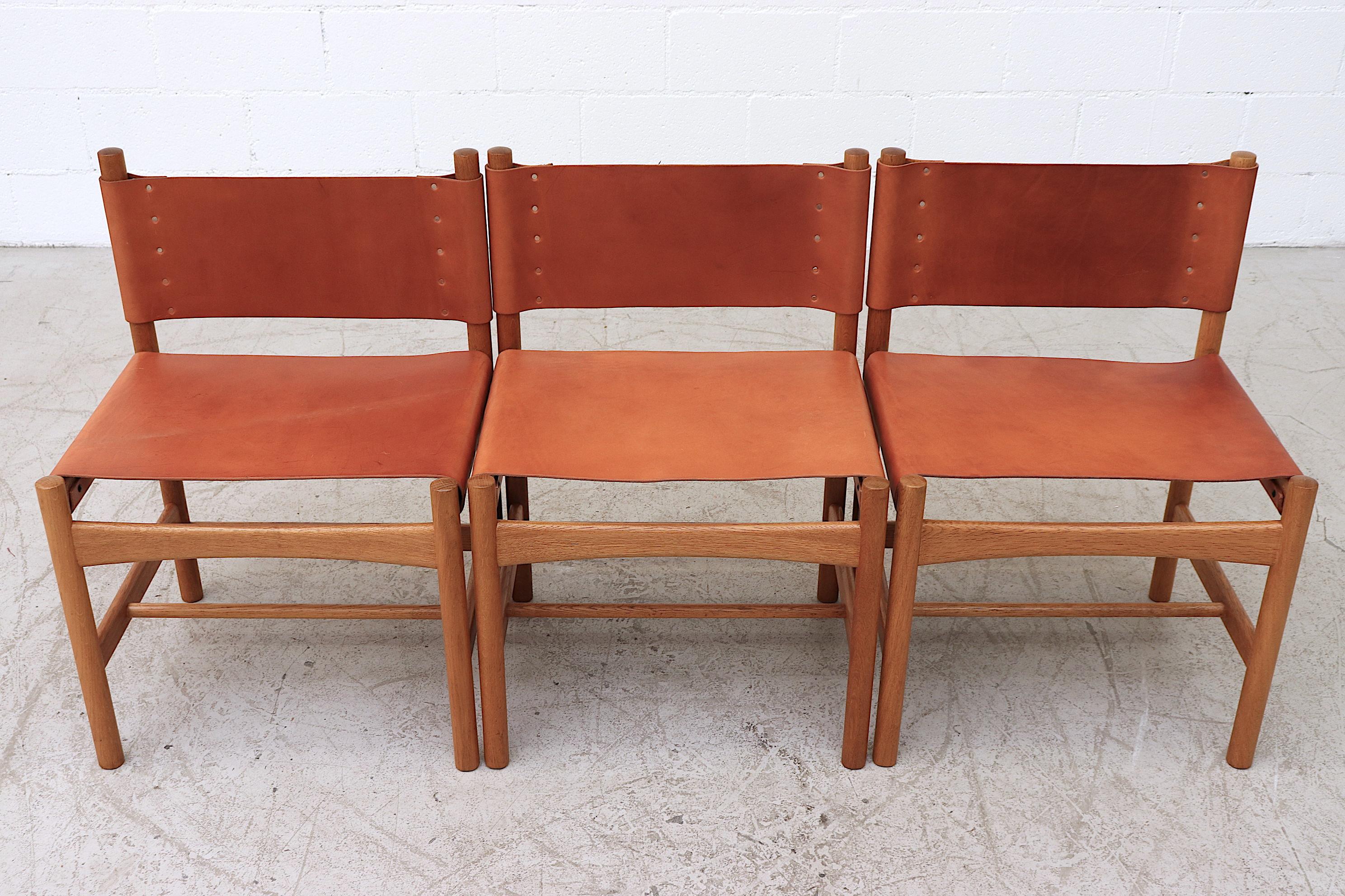 Set of 6 Børge Mogensen oak and custom leather dining chairs with lightly refinished frames and new custom oiled leather seats and backs, not to original specs. Frames in good original condition with moderate wear consistent with age and use.
