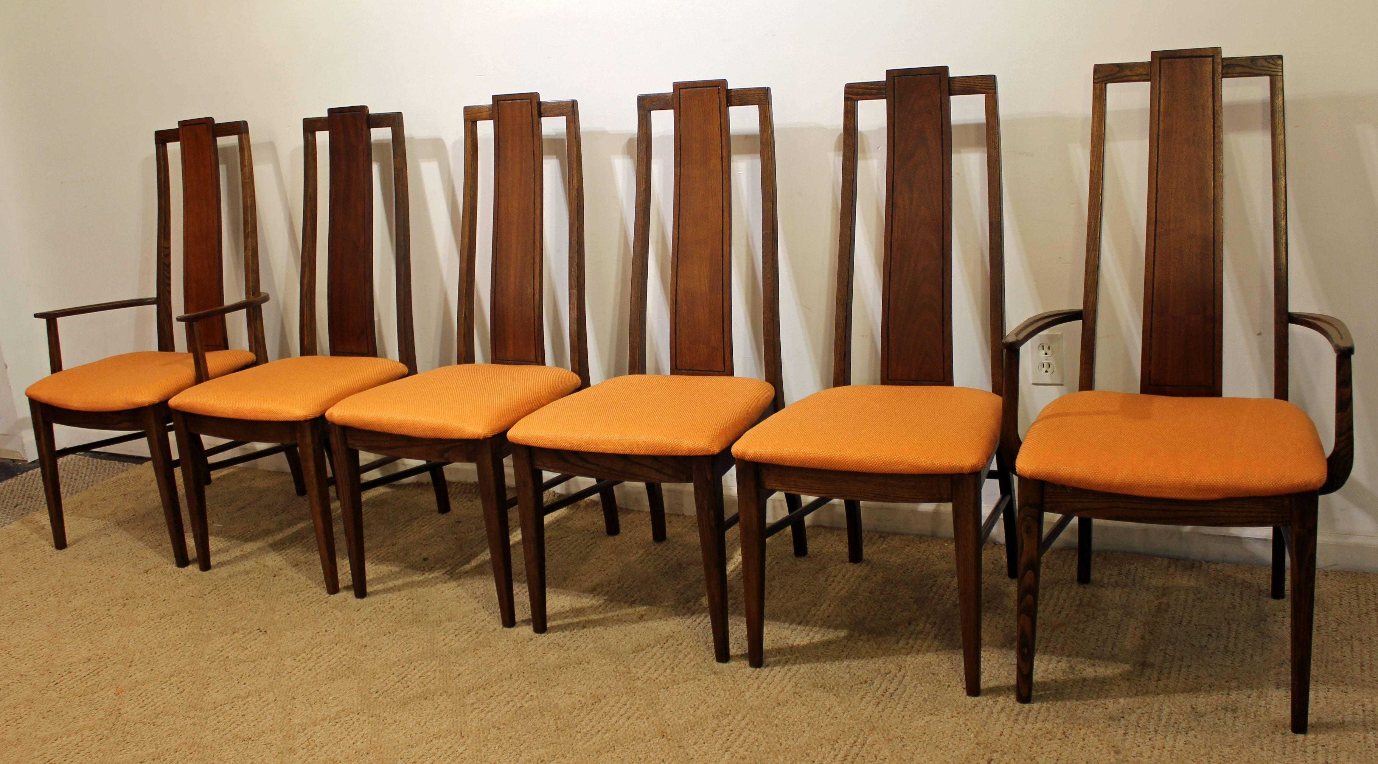 This set includes four side chairs and two armchairs. They are made of walnut and have been refinished and reupholstered with orange fabric. 

Measures: side chairs: 18.5