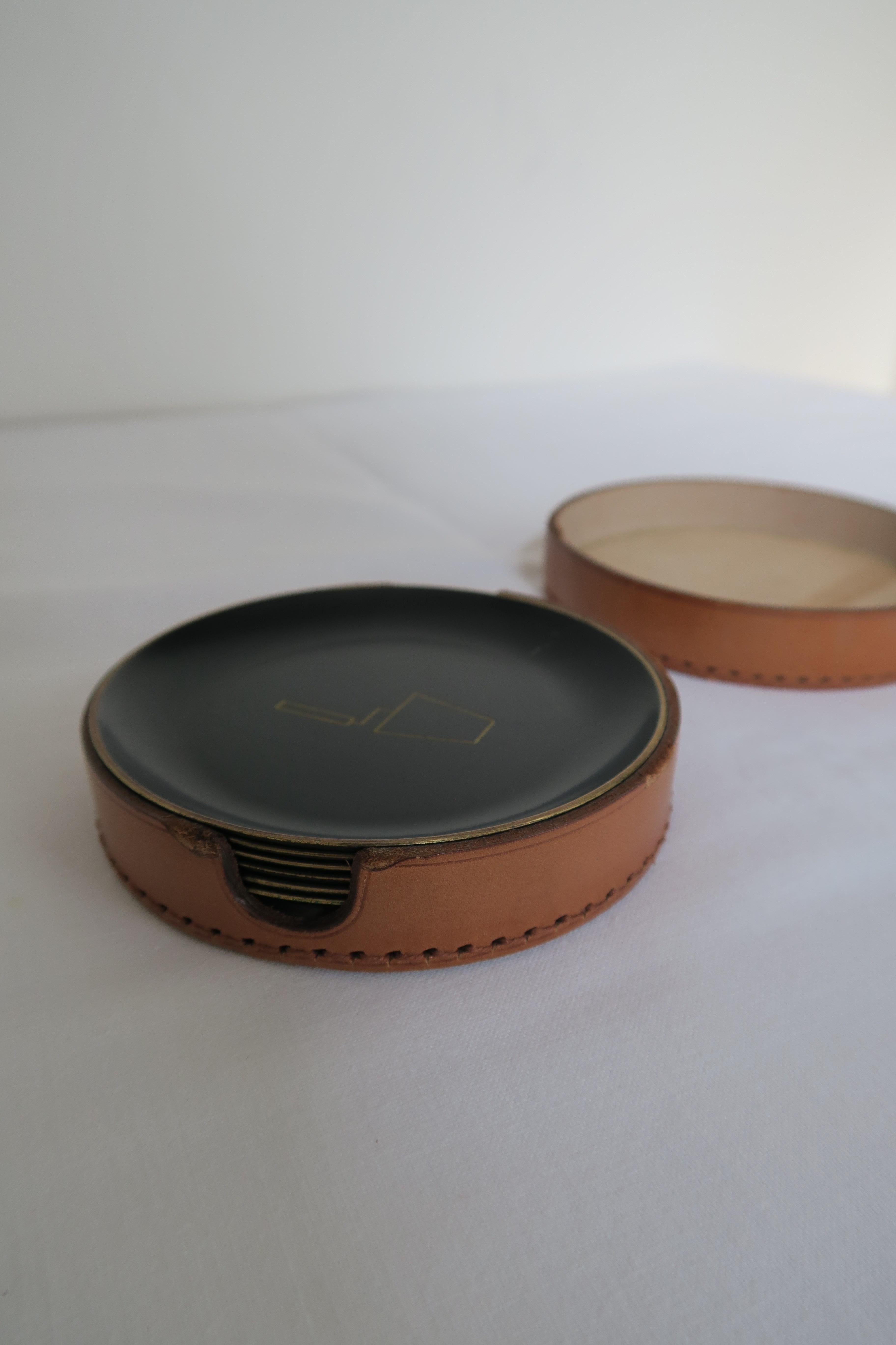 Original set of 6 coasters attributed to Austrian Bauhaus designer Carl Auböck. The coasters are made from brass and feature freemasons motives. They come with a nice and sturdy circular leather case.
Everything is in nice condition, without