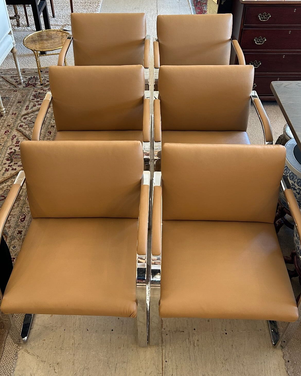 Classic mid century modern iconic BRNO style armchairs originally designed by Ludwig Mies Van der Rohe for Knoll.  These are vintage since you can see where the steel is sottered on the bottom.  We think the tan upholstery in supple leather, but