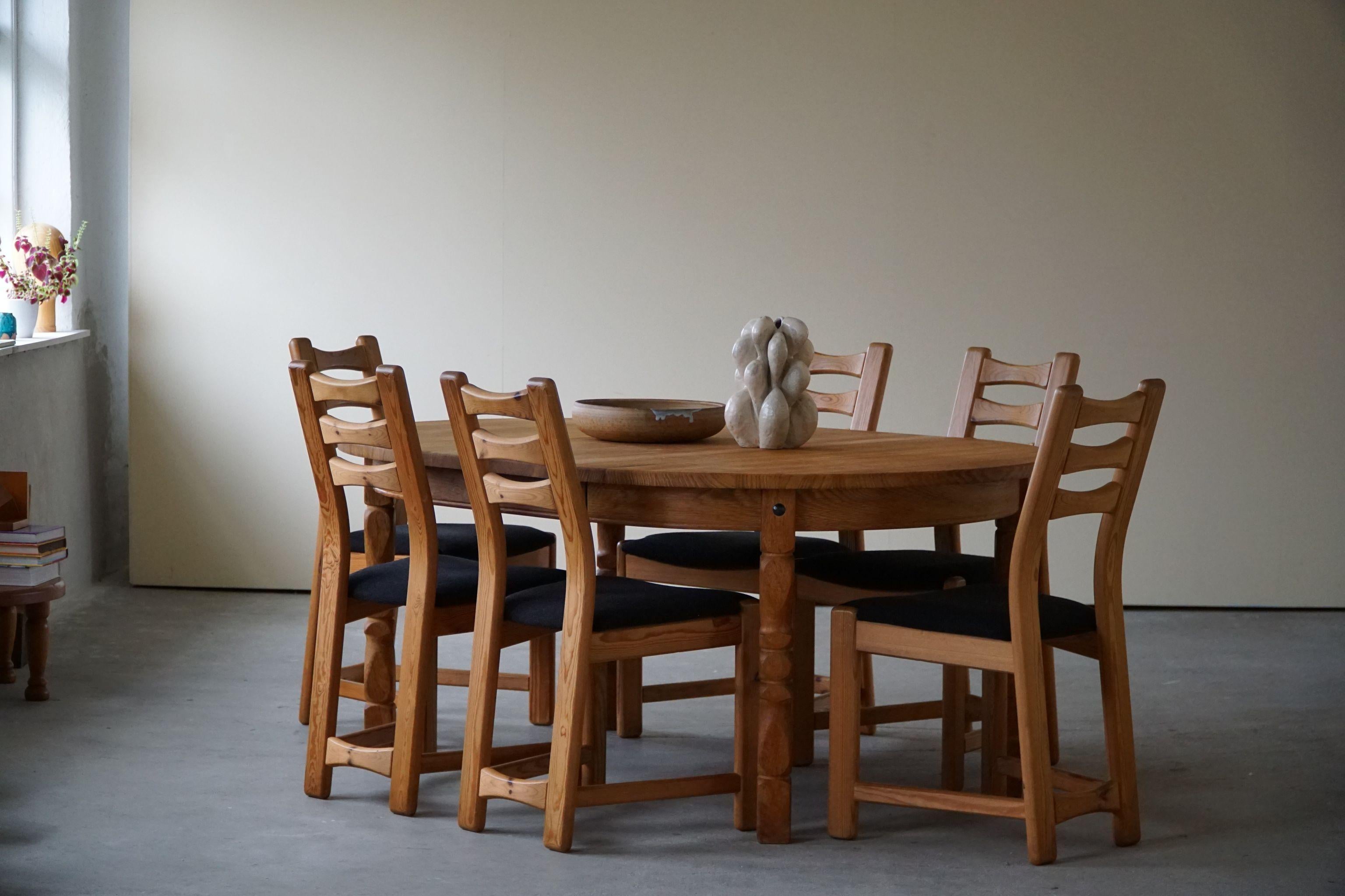 Set of 6 sculptural dining chairs in solid pine, reupholstered in black wool from Nevotex. Made by a Danish Cabinetmaker in 1970s. These brutalist chairs have a really strong impression that pair well with many types of interior styles. A Modern,