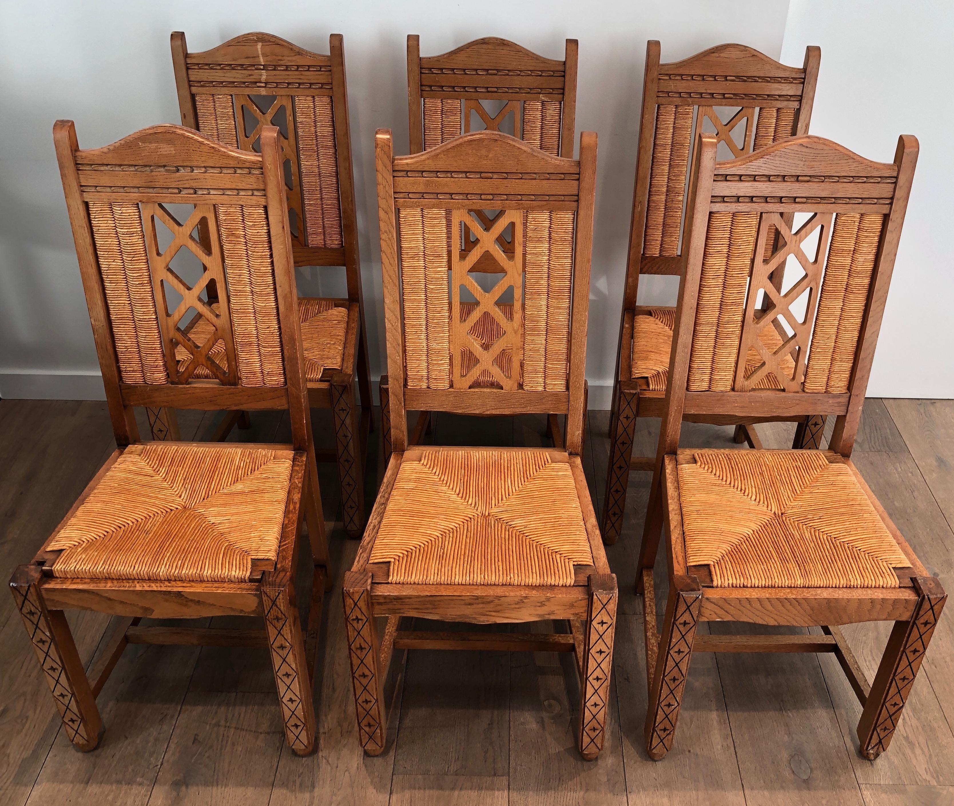 This set of 6 unusual Brutalist chairs is made of ash wood and straw. This is French work, circa 1950.