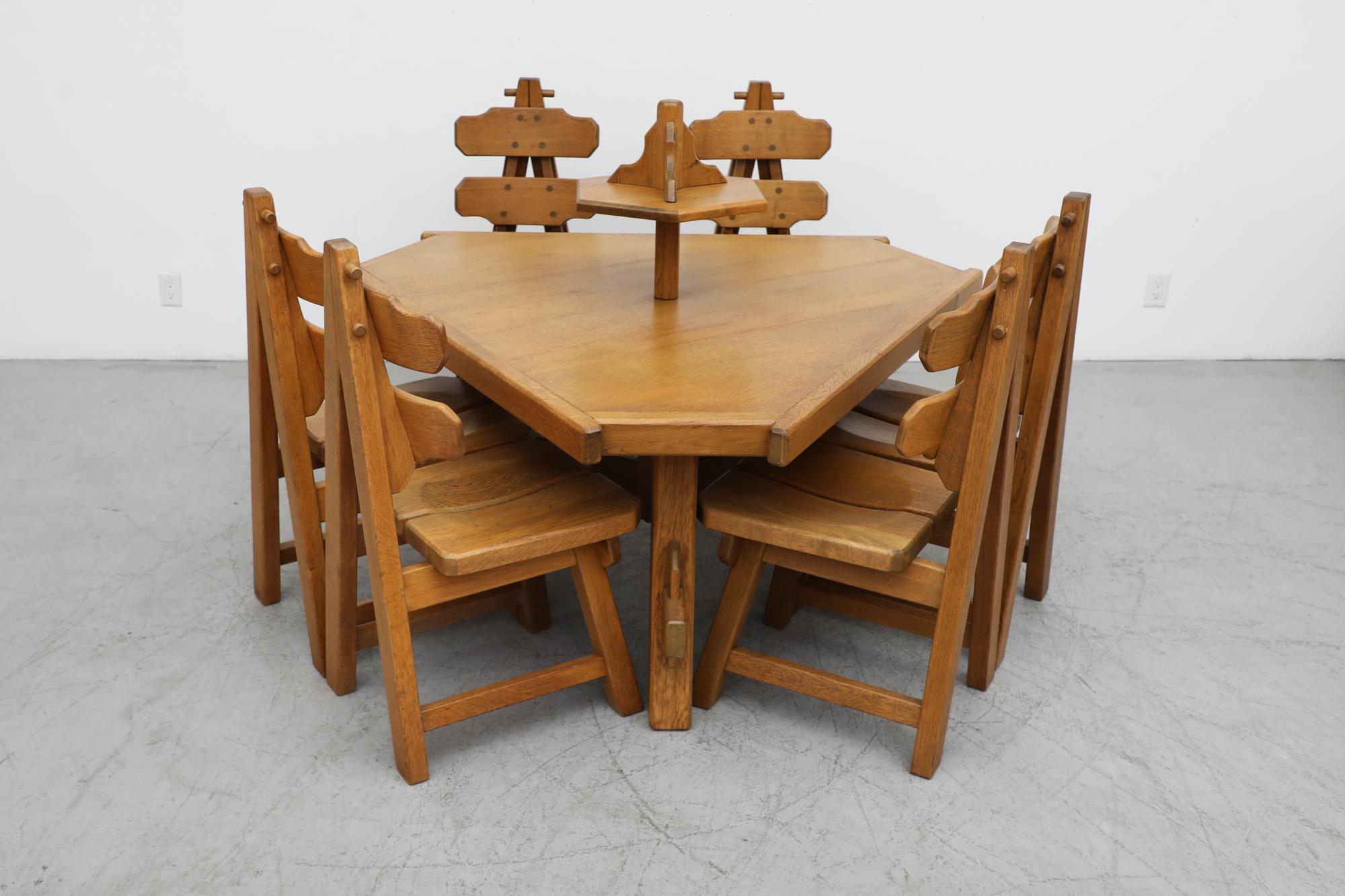 A stunning example of folk furniture most commonly found in Southern Germany, Austria, Switzerland, the Czech Republic (i.e., in the Alps and their surroundings) this set of 6 Brutalist heavy dining chairs is made from solid oak with an 
