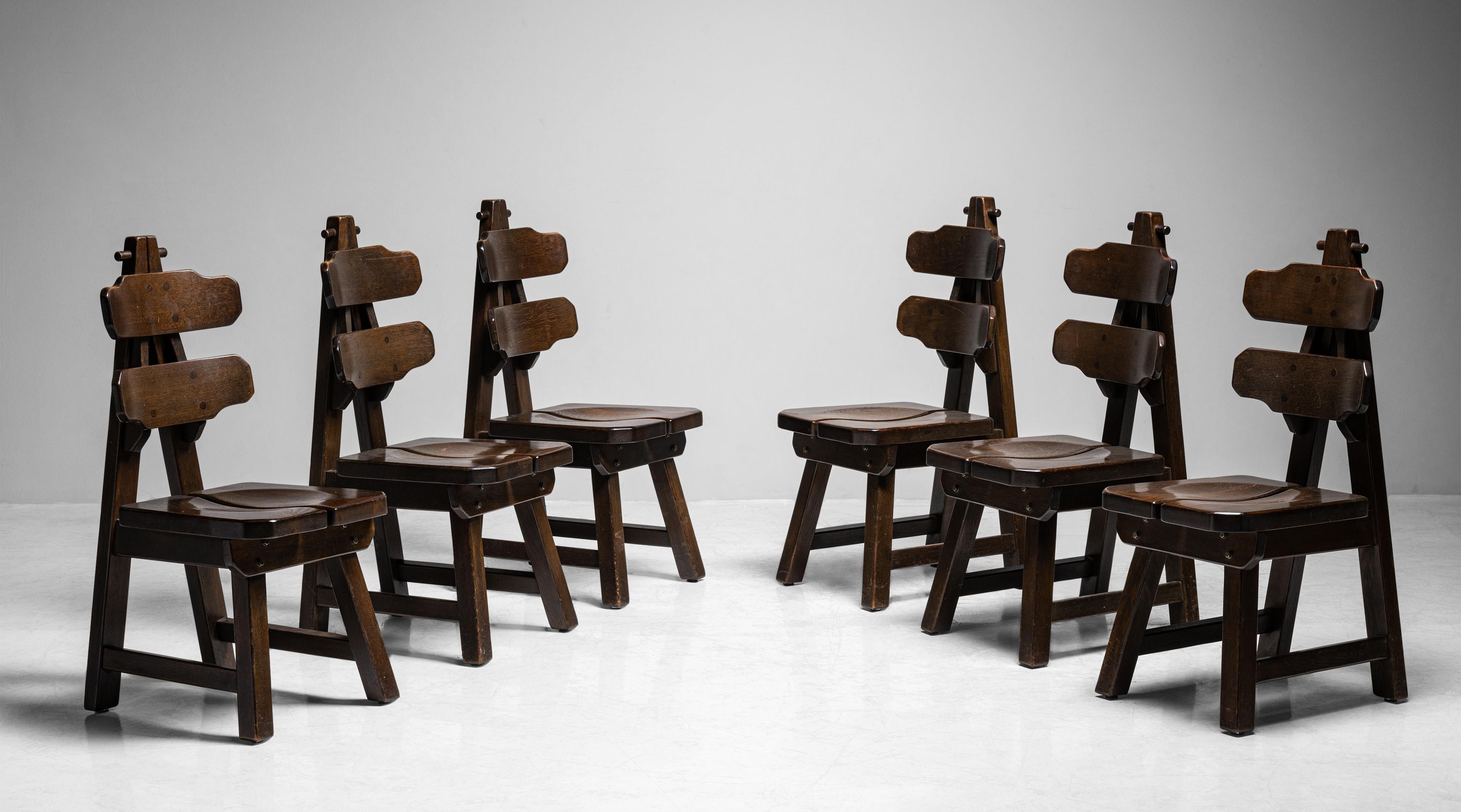 Set of (6) Brutalist oak dining chairs

France, circa 1970

Quality design and joinery. Curved oak seat and back, in original dark stain.

Measures: 17.75