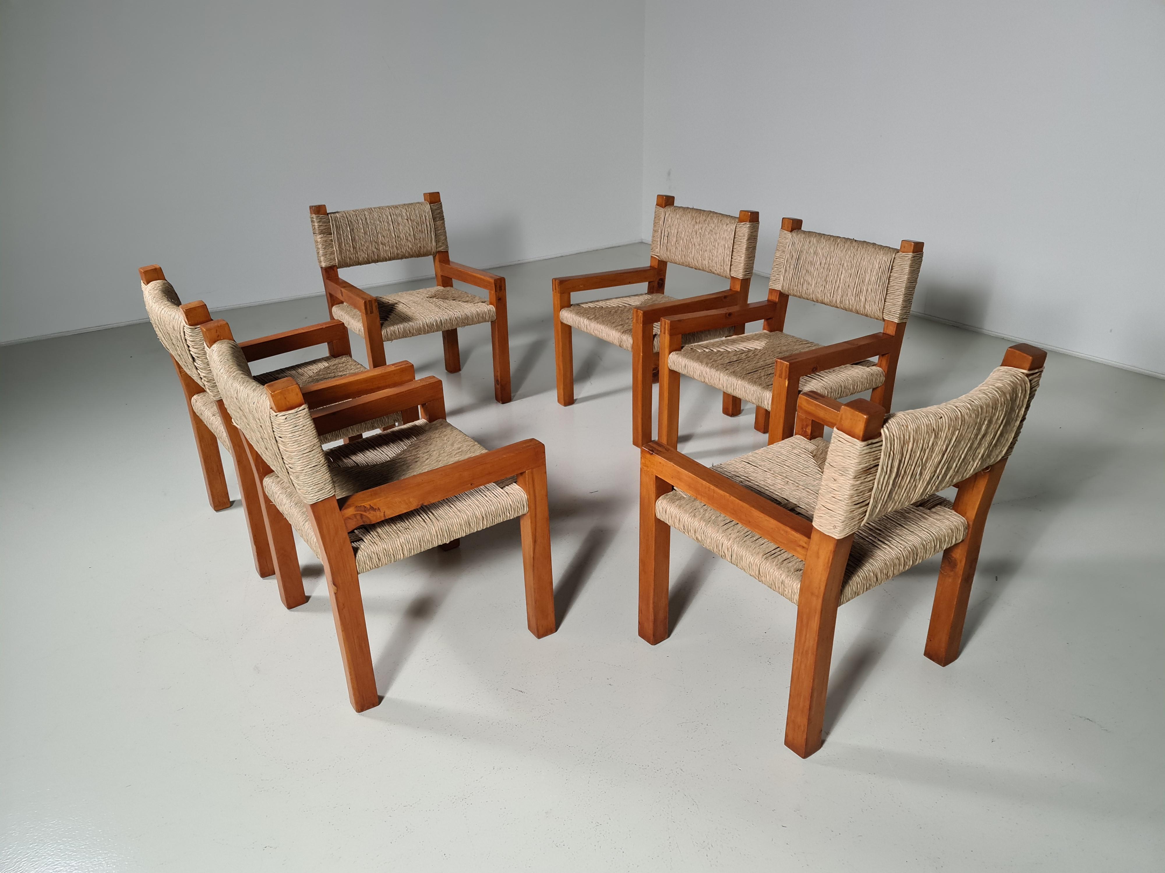 Rare set of brutralist style pine dining chairs with woven paper cord seats. The elegant designed open shape of the frame in combination with the natural colored seats makes this chair very versatile for any type of interior. The design looks