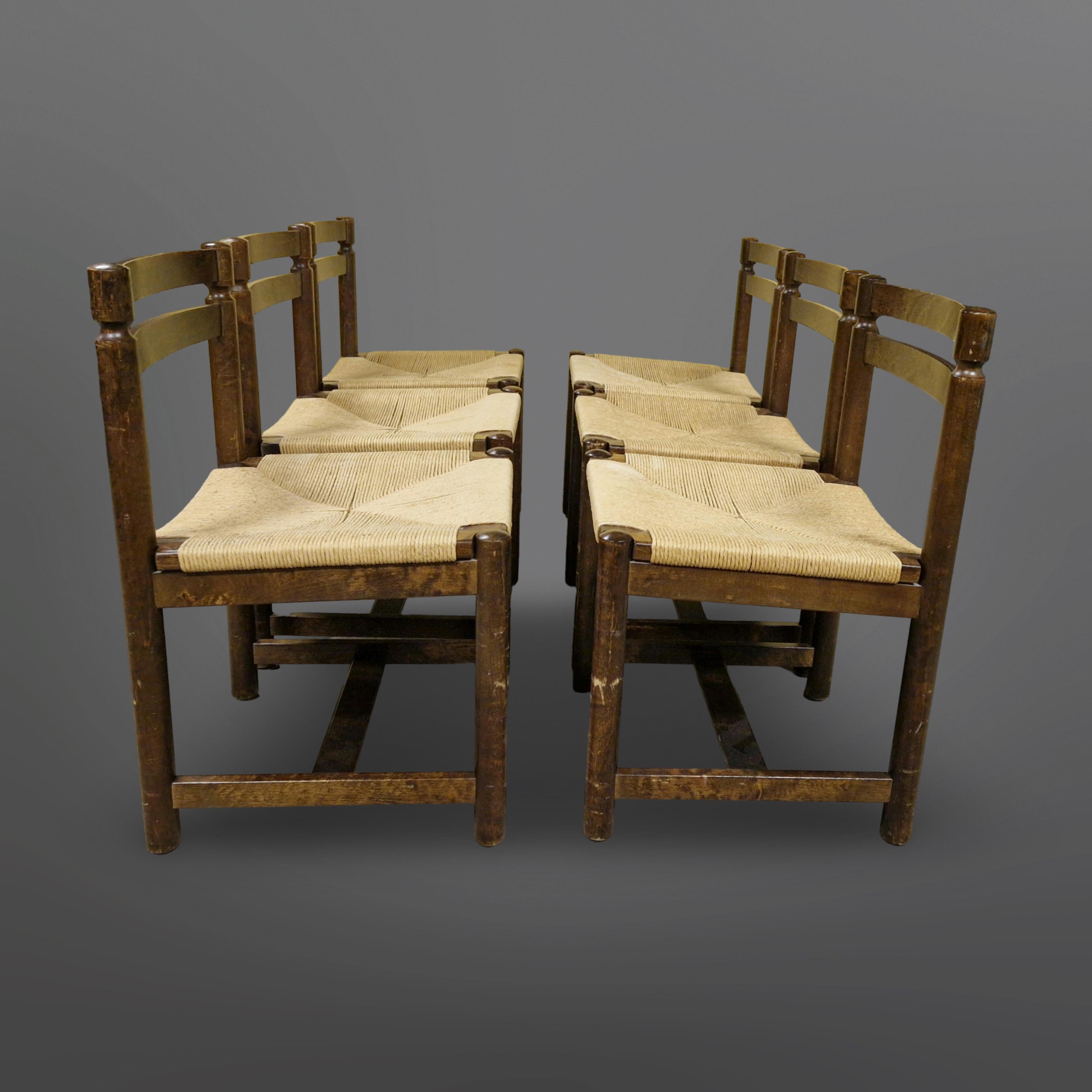 Set of 6 solid wood dining chairs. Designed in the style of Charlotte Perriand and Pierre Jeanerette. The seats are handwoven with papercord. The chairs have some signs of wear consistent with age and use. The seats are in very good condition.