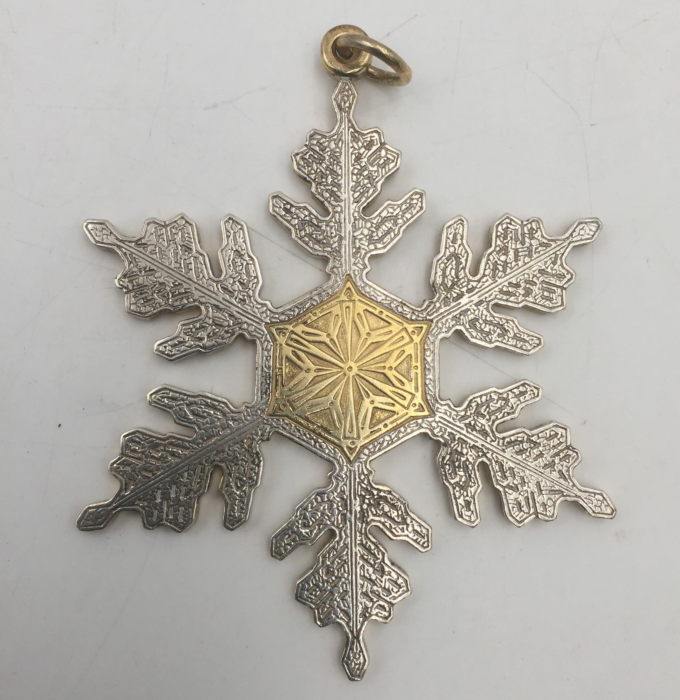 Exceptional assortment of 6 Buccellati sterling silver Christmas ornaments, all made in Italy, consisting of:

- an engraved snowflake, gilt at the center and on top, measuring 3 1/2'' in height by 3'' in width

- a winter village scene in