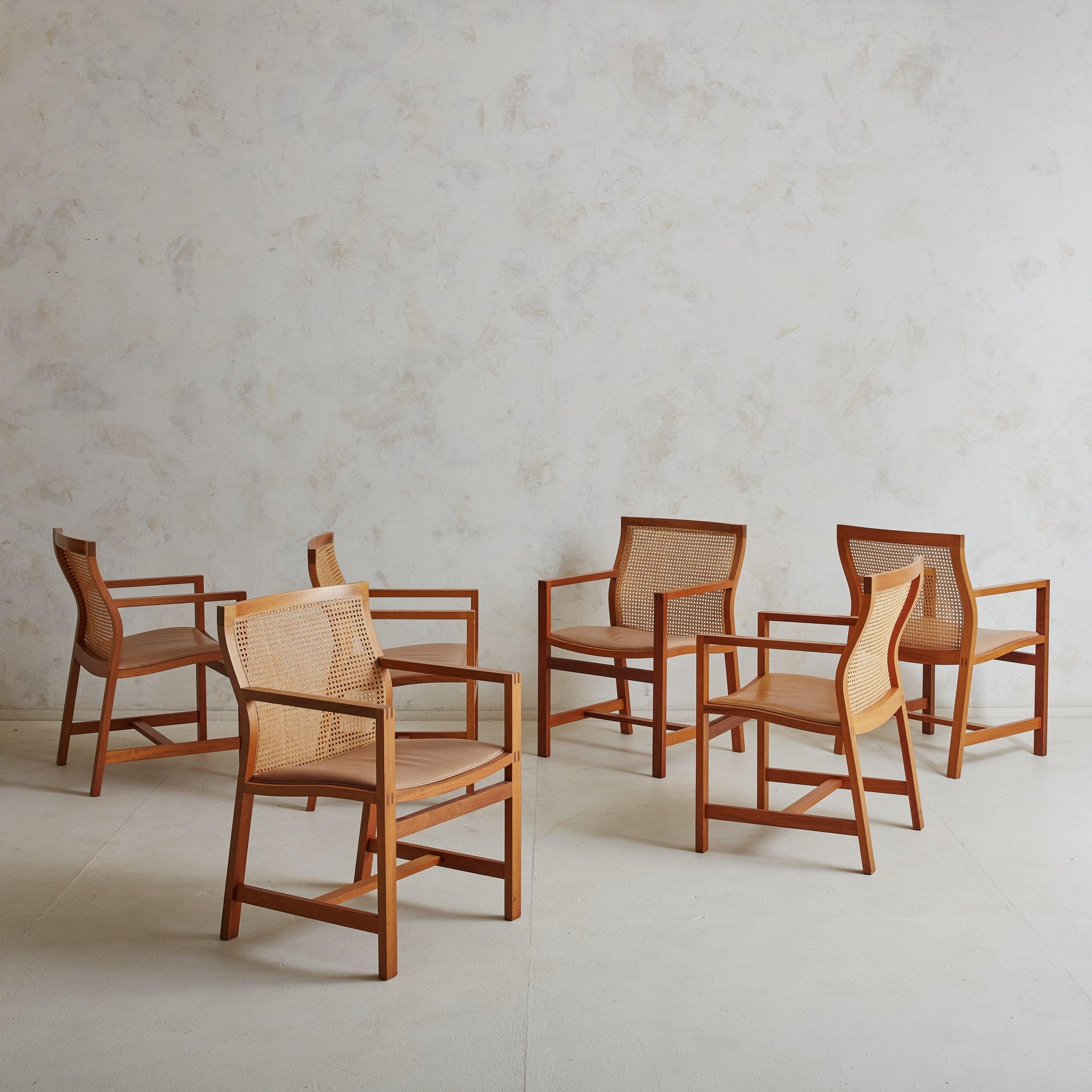 Set of 6 Danish Modern cane and cherry wood dining chairs designed by Rud Thygesen and Johnny Sorensen for Botium in the 1980s. These exceptionally crafted dining chairs are constructed of minimalistic cherry wood frames, patinated tan leather