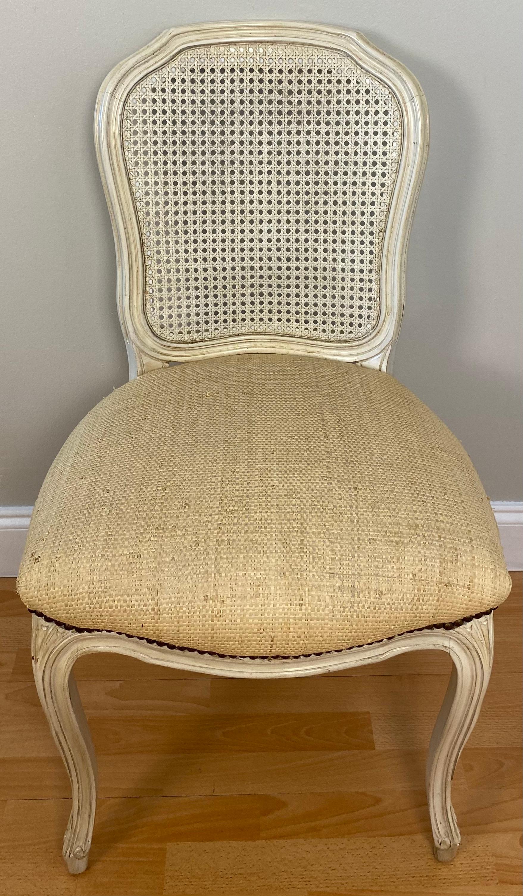 A very good quality set of six caned comfortable and sturdy French Louis XV style dining chairs in a pleasing cream colored or beige finish. 

The well crafted wood frames are sturdy and comfortable enough for daily use. Caned back and upholstered