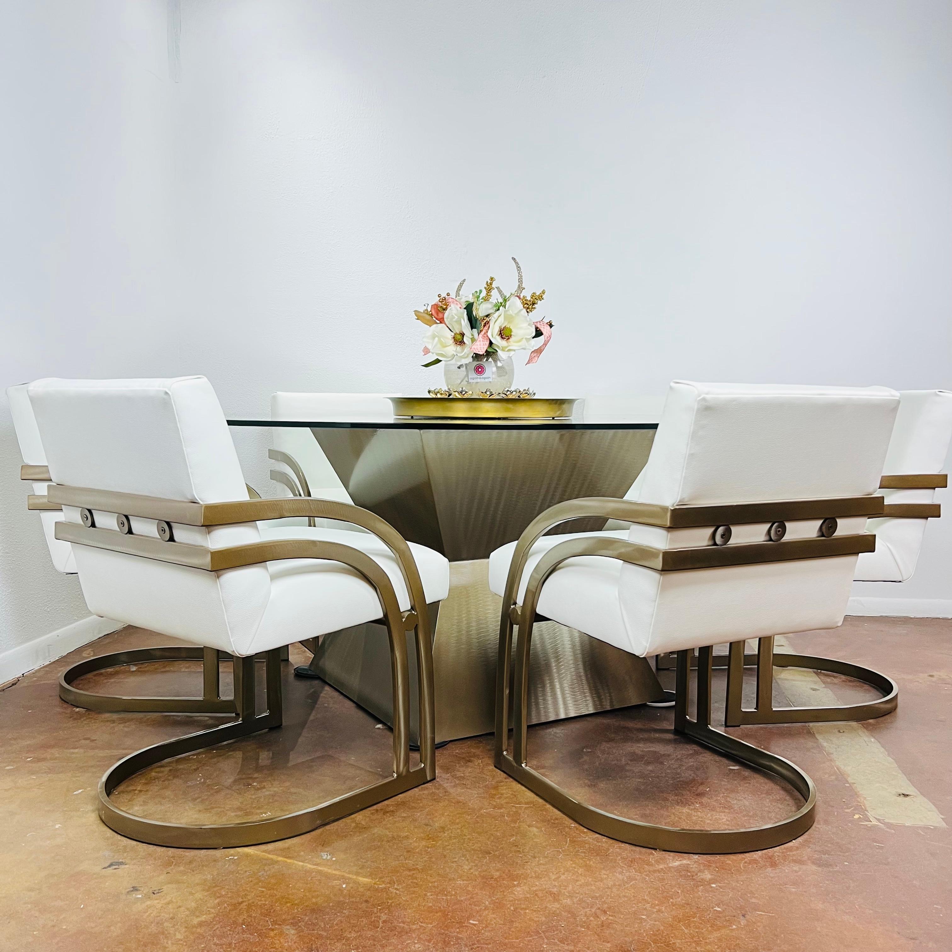 Set of 6 contemporary cantilever dining chairs with antique bronze finish and white vinyl seats. In the Style of Milo Baughman. Very good, lightly used condition.