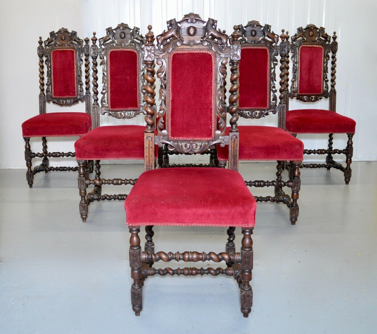 We are delighted to offer for sale this set of six, solid oak, lion hand-carved, gothic jacobean dining chairs. A very decorative set of chairs with elaborately carved backs, each upholstered in red velvet with a scrolled cresting on turned legs.