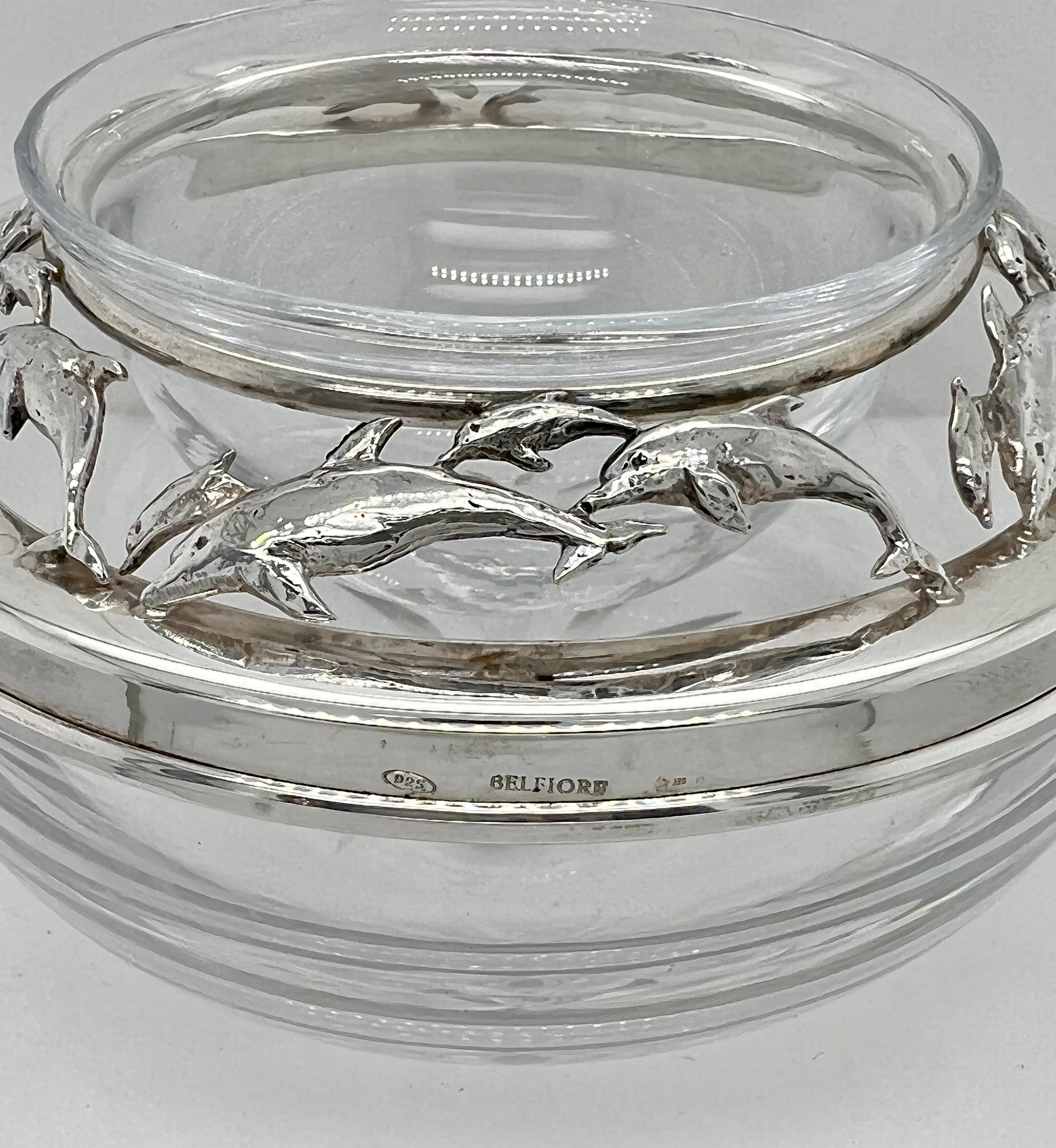 Unique and fabulous set of six individual caviar servers. Each server is comprised of a very heavy crystal bowl, with a cut rayed base. There is a removable sterling collar, with a cut-out design of swimming and diving dolphins. Finally, there is a