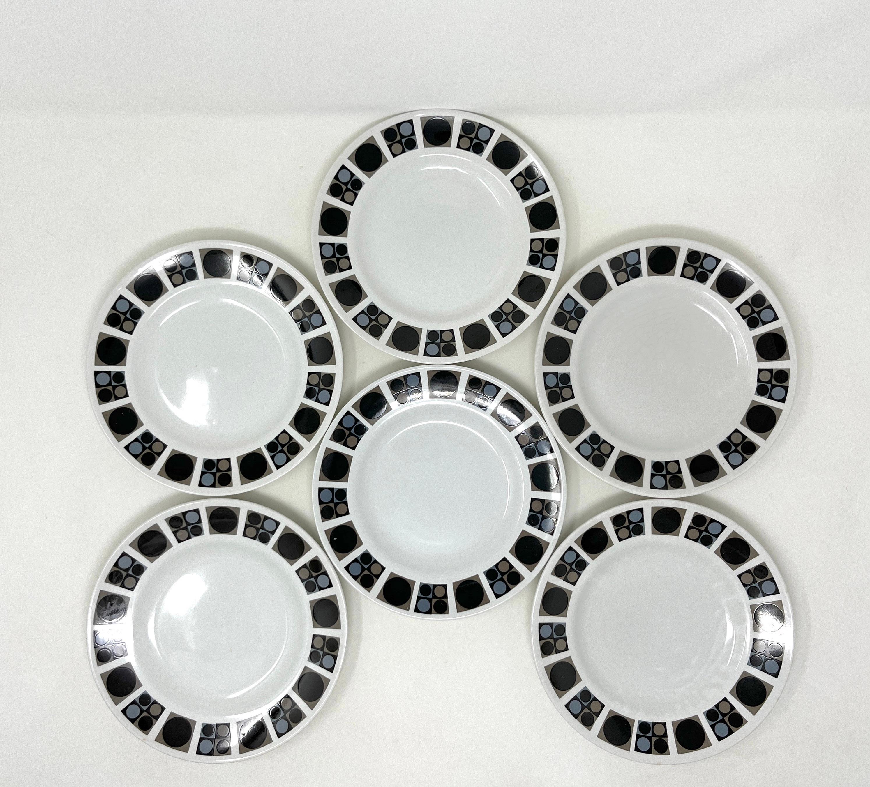 Set of 6 English earthenware tea plates with printed overglaze decoration in the 'Focus' pattern. Made by W. R. Midwinter Ltd., Burslem, England, 1964.

The broad rims are decorated with panels of single or four circles in brown, black and