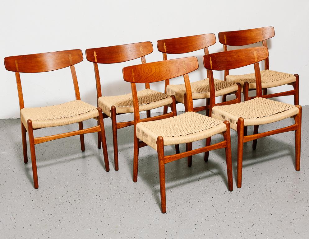 Set of 6 CH23 dining chairs by Hans Wegner for Carl Hansen & Son. Early Wegner design with oak frames and teak backs. Newly wrapped Danish cord seats.