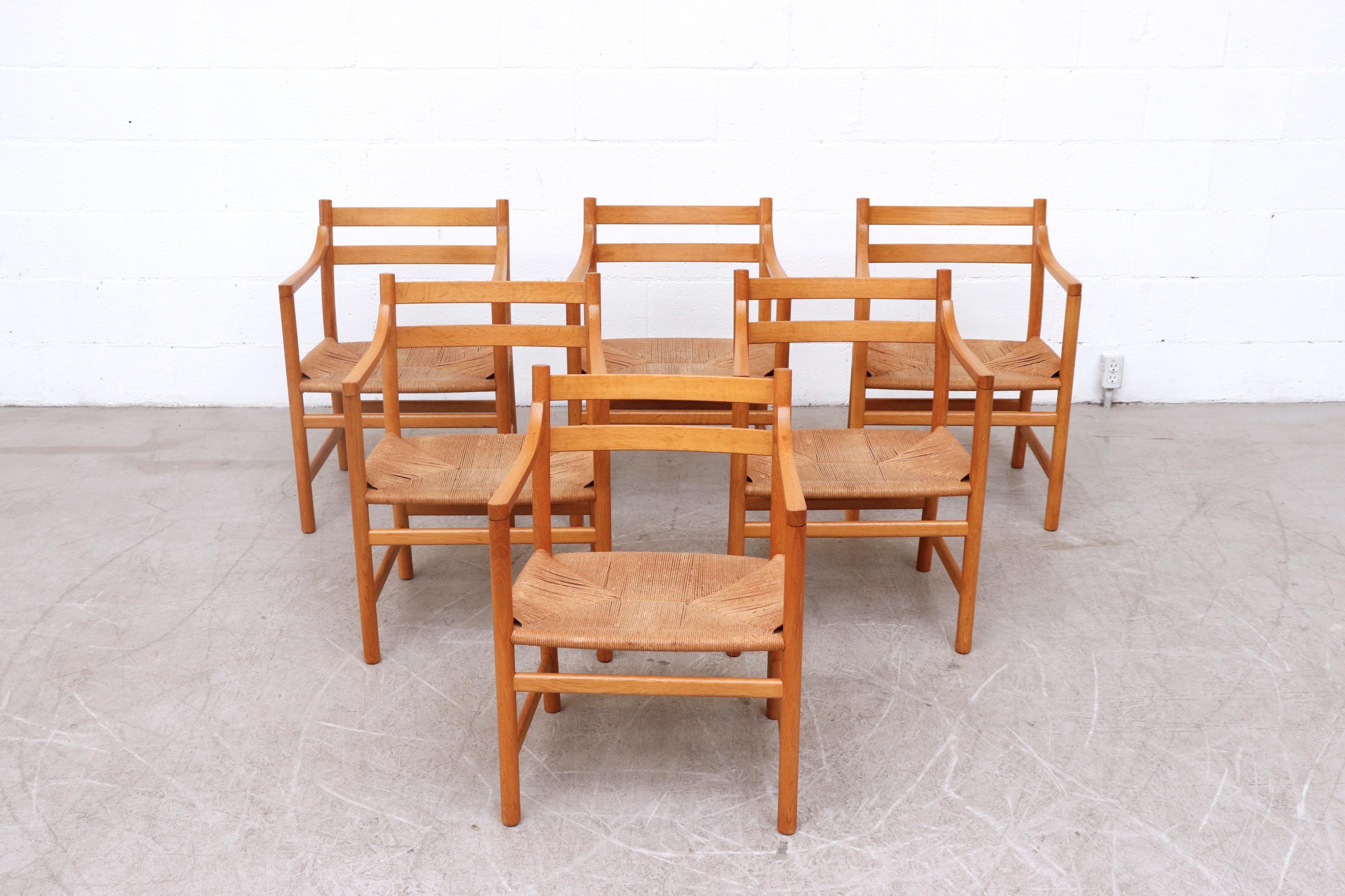 Set of 6 beautiful midcentury natural oak armchairs with paper cord seating. The 1965 design of the CH46 chair perfectly showcases Hans J. Wegner’s Affinity for Functional, elegant simplicity. In original condition with minimal wear and loss.