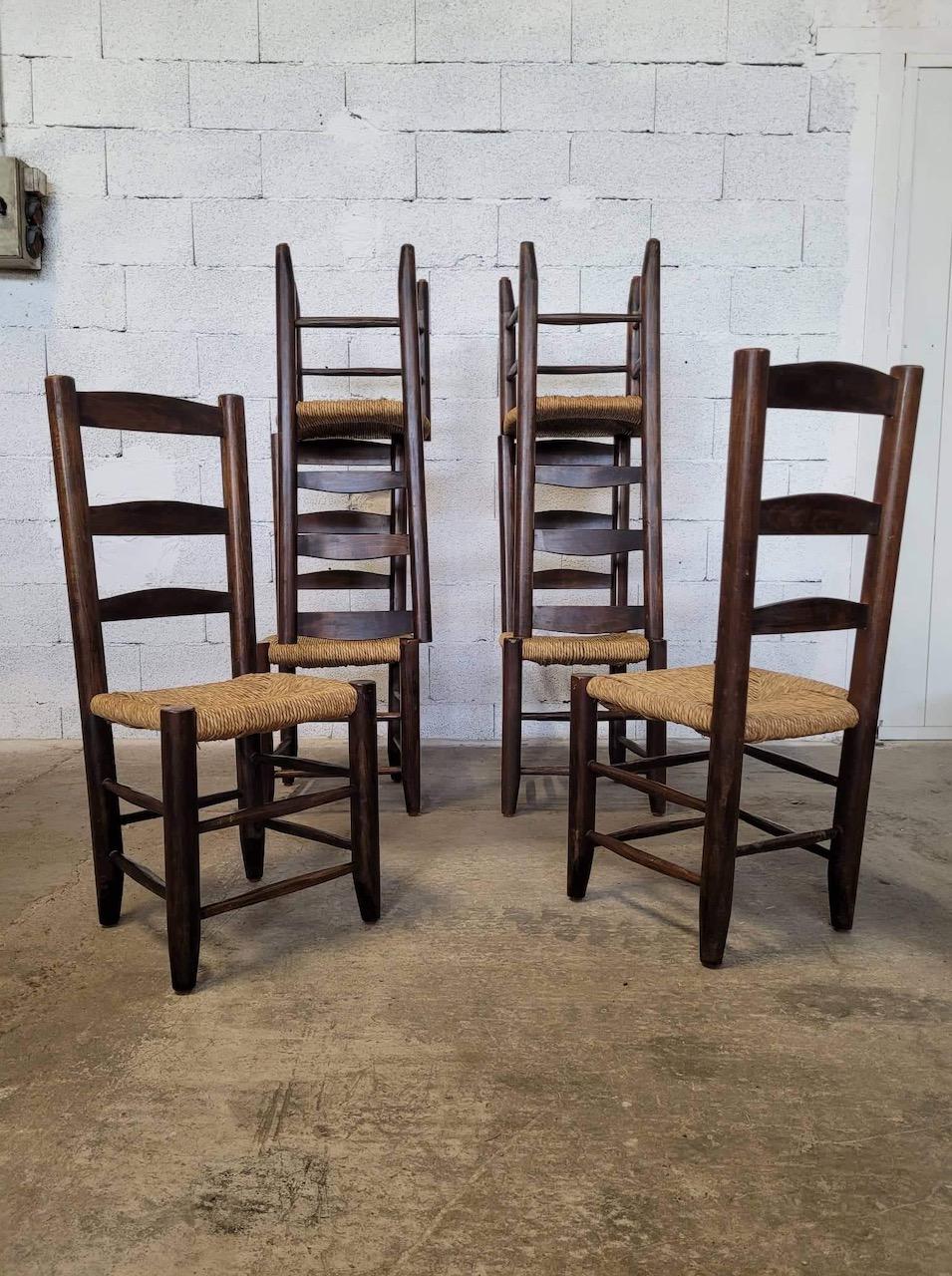 Set of 6 chairs with straw and oak seat in the style of Charlotte Perriand 1950. Good condition. High backrest. Gouge-worked spacer bars. 
Dimensions: High. 100 cm width. 40 cm deep 40 cm.