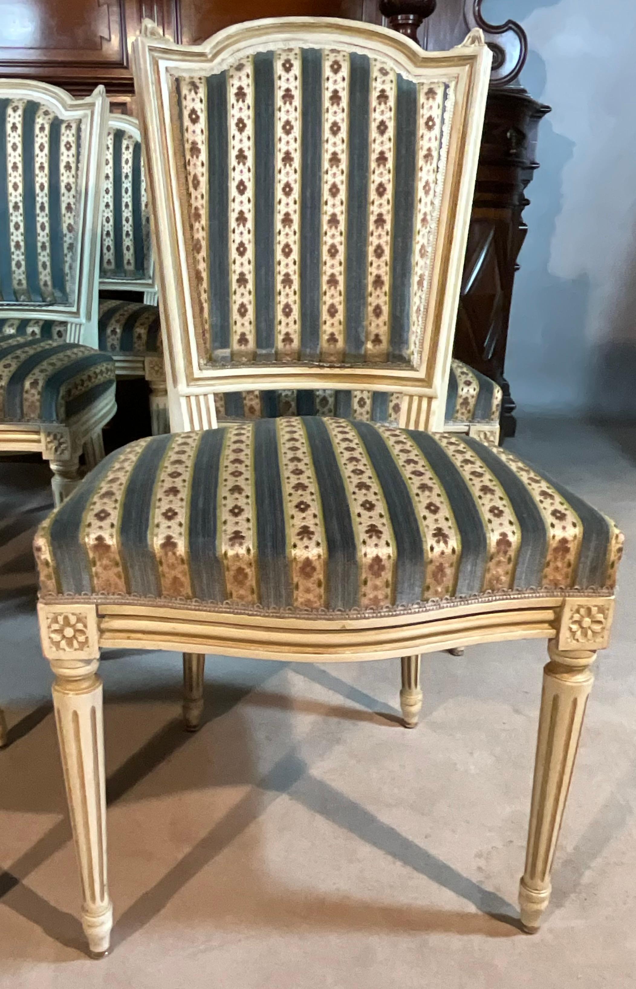 Set Of 6 Chairs And A Louis XVI Armchair Late 19th Century.

The seat is upholstered with fabric. The seat backs are rigid, rectangular and straight. The seat itself is rectangular.

All woodwork is in very good condition and painted. The paint and