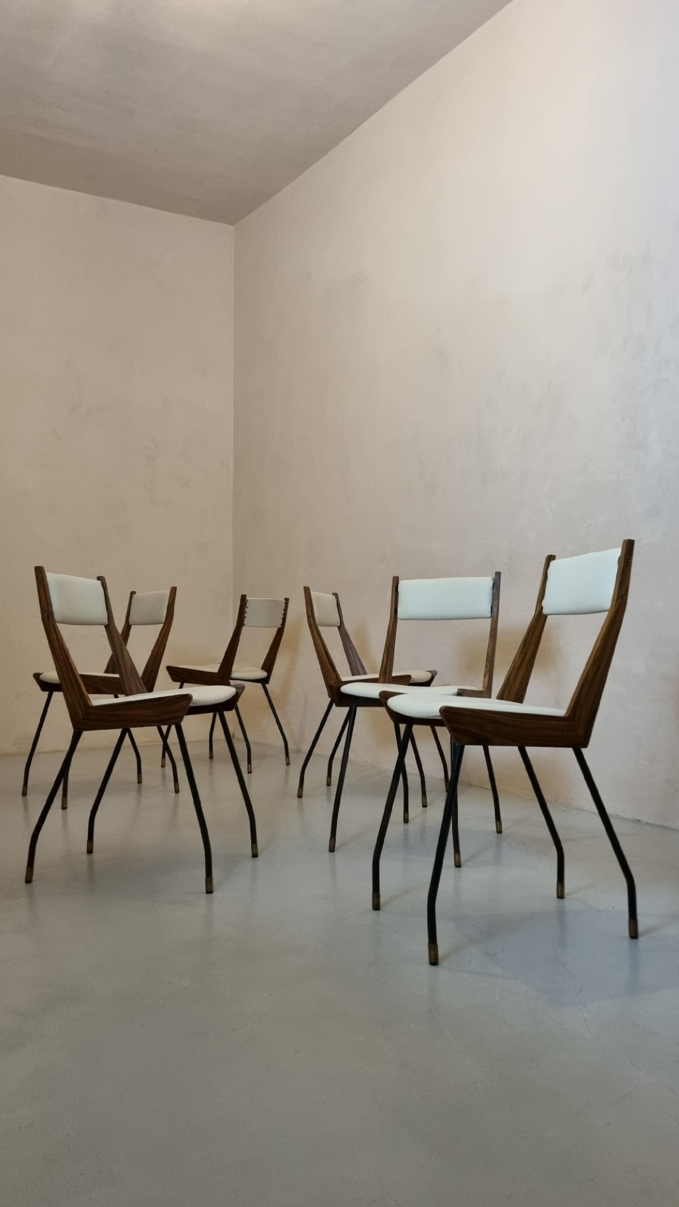 Set of 6 chairs designed by Carlo Ratti in the 1950s for Industria Legni Curvati.
Iron frame, brass feet, wood veneer, leather seats. 
The chairs have been restored respecting the original details, leather reupholstered seats, wooden armrests with