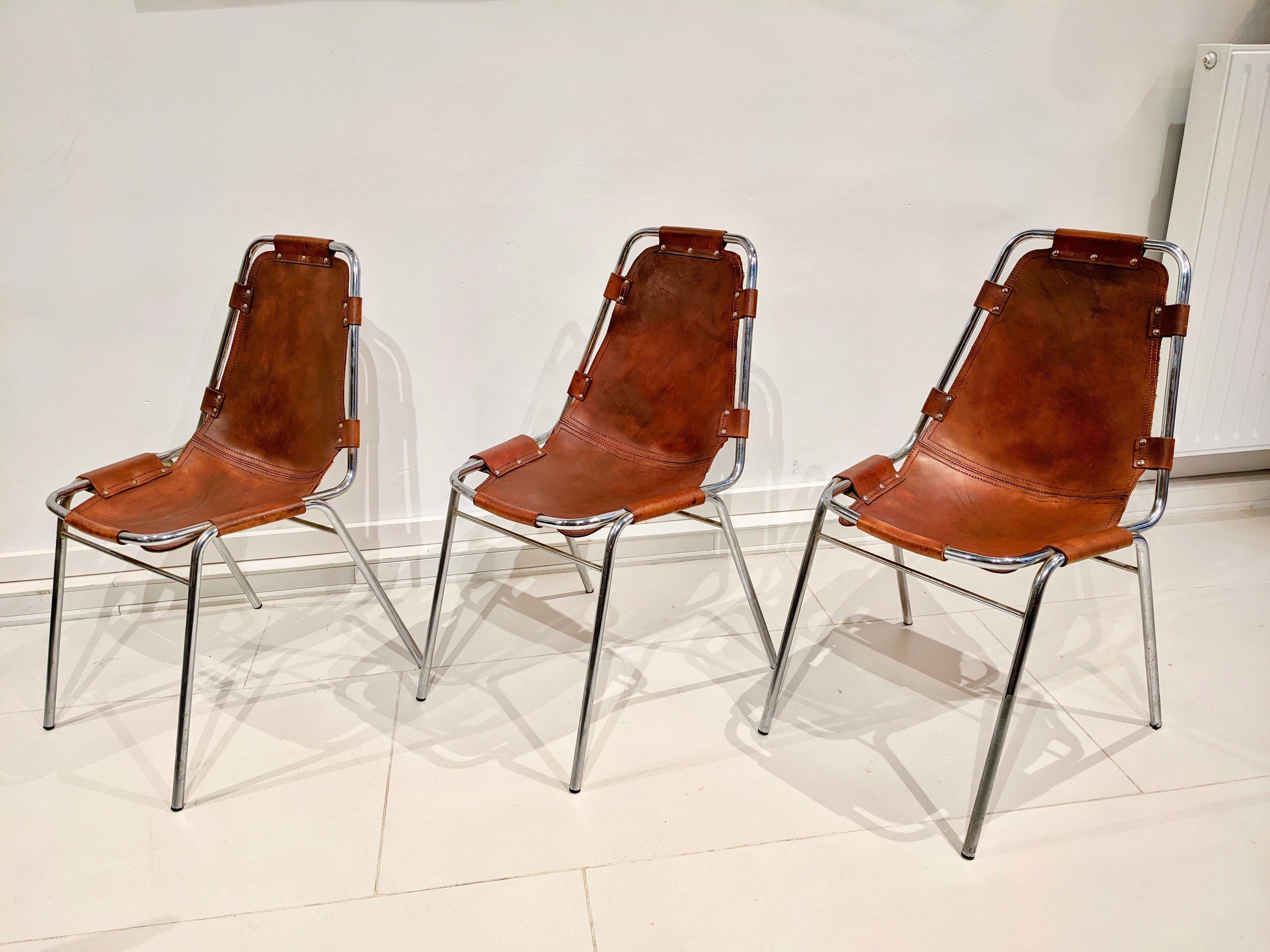 Set of 6 chairs by Charlotte Perriand for Les Arcs in cowhide. Good condition. Circa 1970

2 chairs have been reshaped at the seat level which explains the different colours of the leather (see pictures). Traces of wear and restoration on the