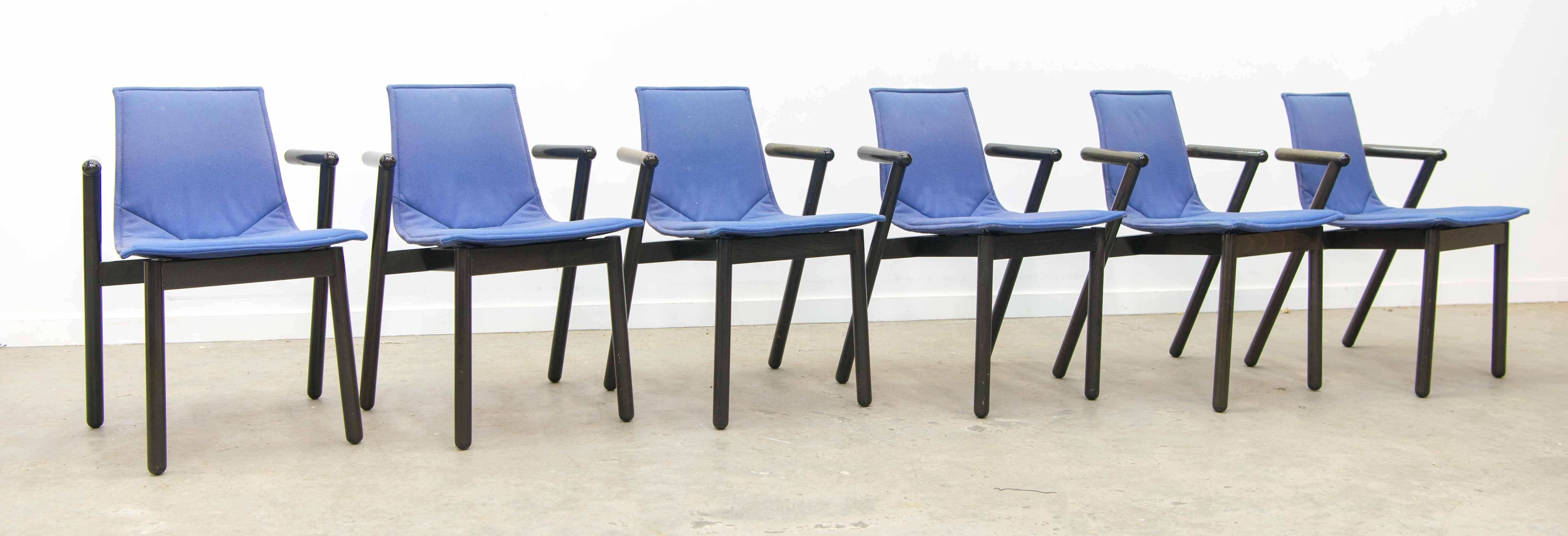 We have for sale this nice set of Cassina chairs, designed by Vico Magistretti. They are very well made and have a solid feeling when holding. They are made of a wood structure with polyurethane and fabric finish. The color is mainly a deep blue.