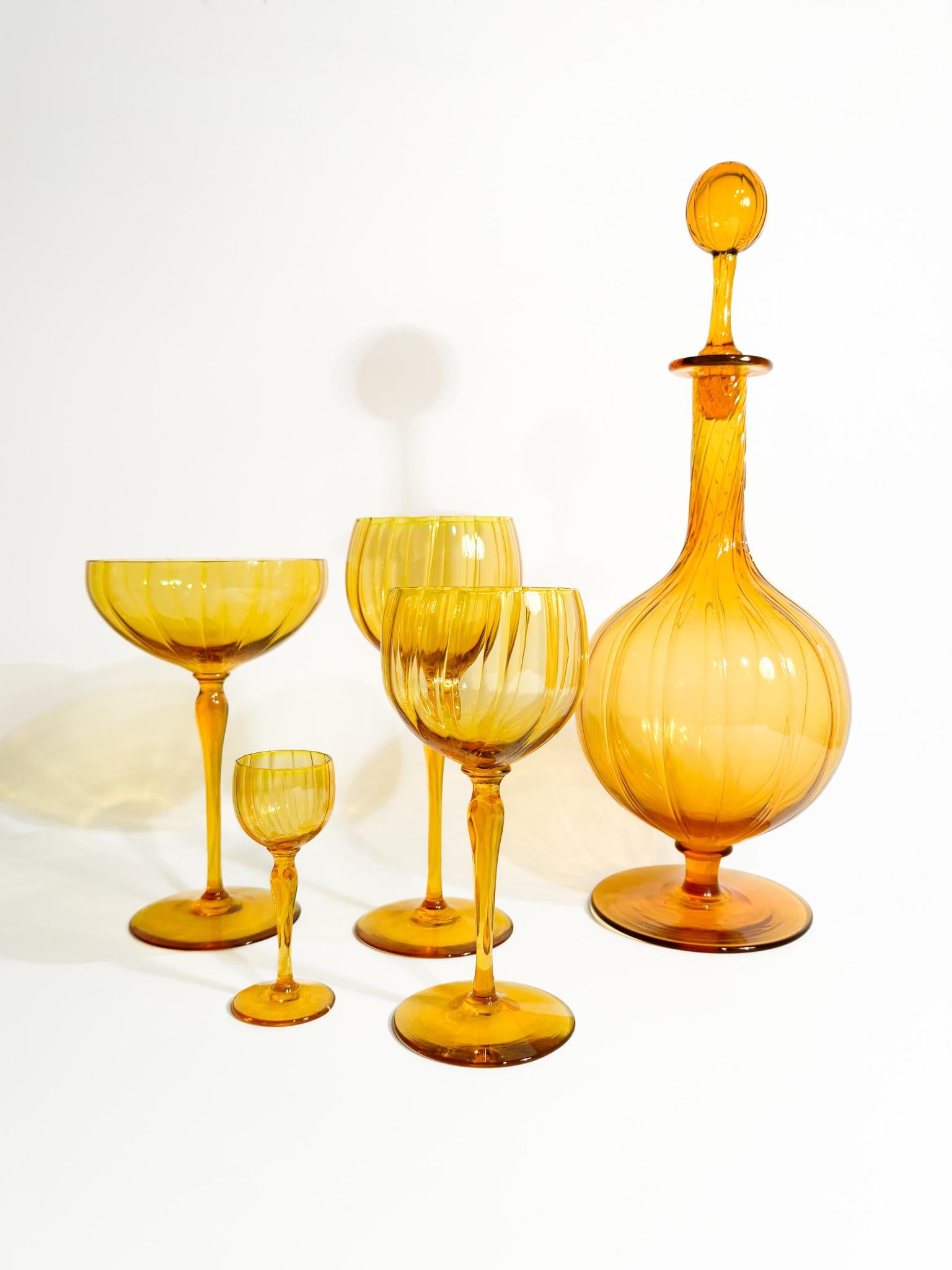 Set of 6 orange non-Murano glass glasses, complete with champagne, wine, water, rosolio and bottle glasses, made in the 1940s. Additional spare parts available, additional information on request.

Bottle: Ø 12 cm h 34 cm

Murano glass is a type of