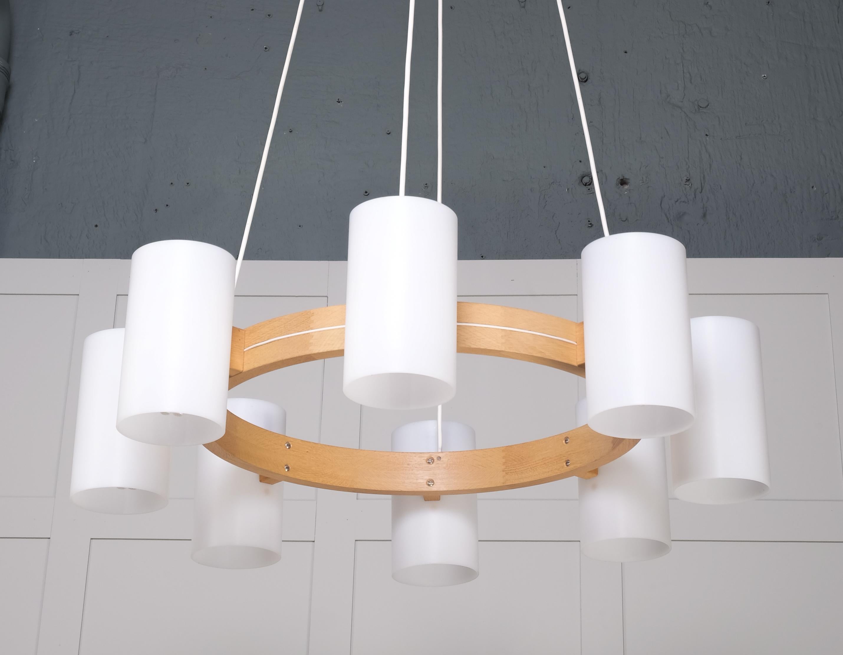 Set of 6 available. Listed price is for one chandelier. Model 587 designed by Uno & Östen Kristiansson, produced by Luxus. Oak and large acrylic shades.
Very good condition. The height is adjustable according to your wishes.