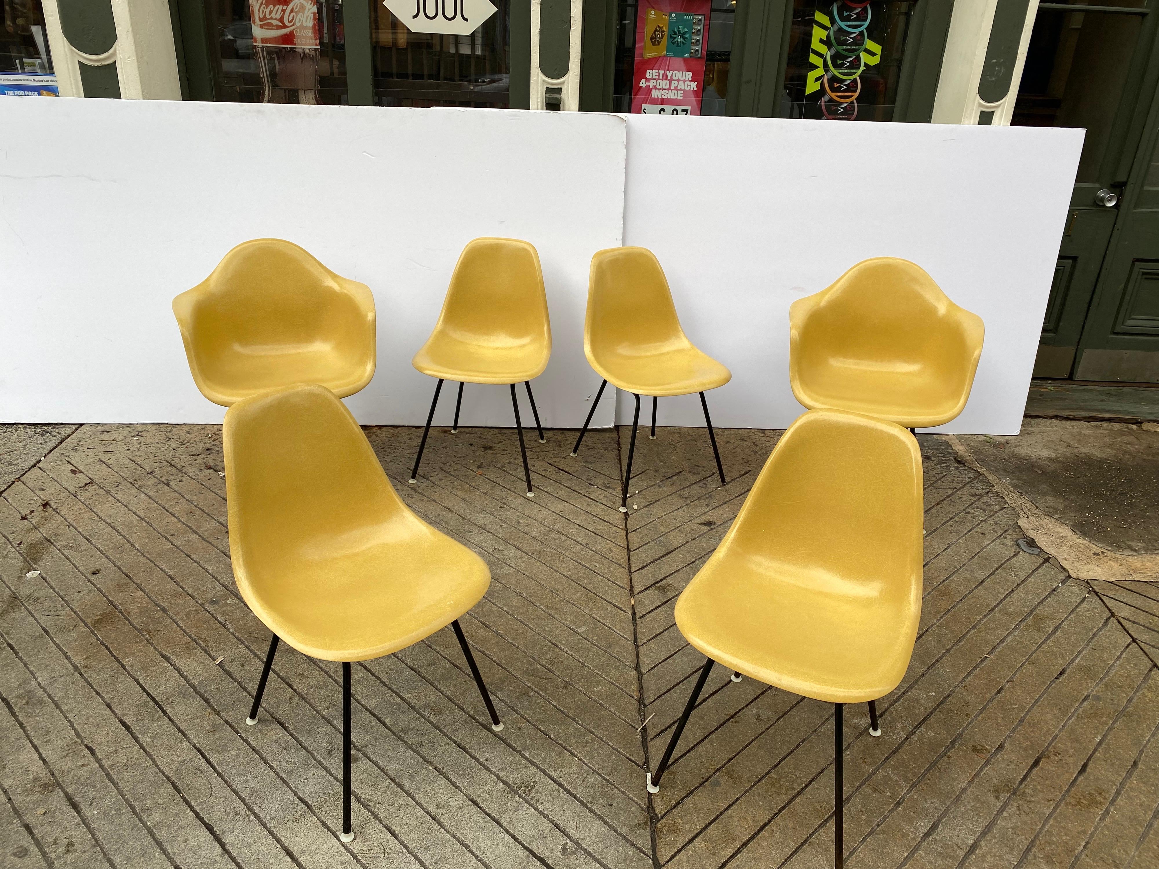 Charles and Ray Eames set of 6 fiberglass chairs, 2 armed and 4 armless models. Chairs are incredibly clean! These had the early vinyl Slip Covers on them so the fiberglass is in great shape! Armchairs measure 24.75