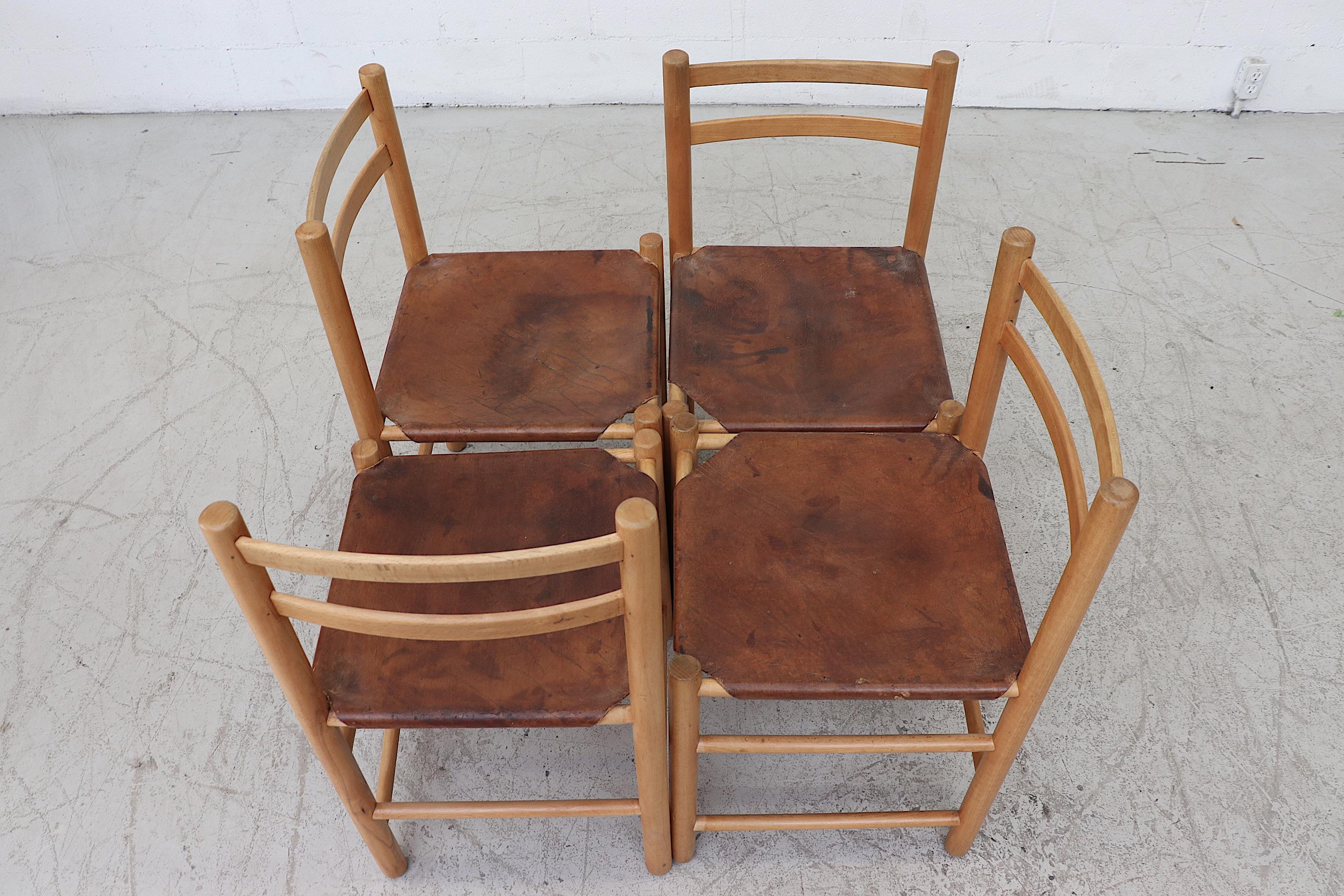 Primitive Charlotte Perriand style dining chairs with rope tied natural leather tanned hyde seats. Original condition - heavy patina on leather - some staining. Leather seating is corset tied to frame set price. Another similar set of 4 available