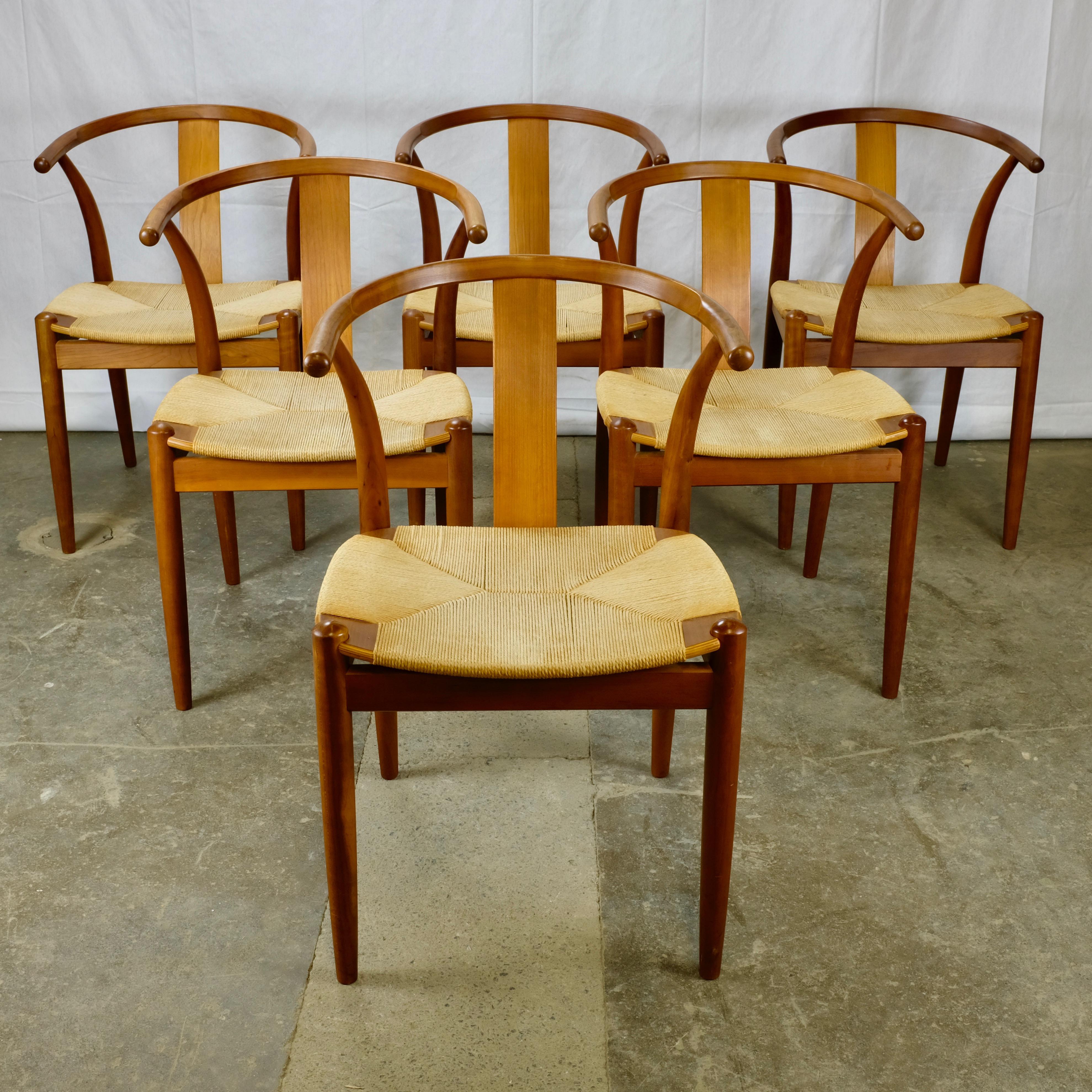 Set of six dining chairs

The frames are solid cherry and feature a curved toprail/armrest supported by the rear legs and by a Chinese-inspired curved back support.

The seats are paper cord woven in an envelope weave.
