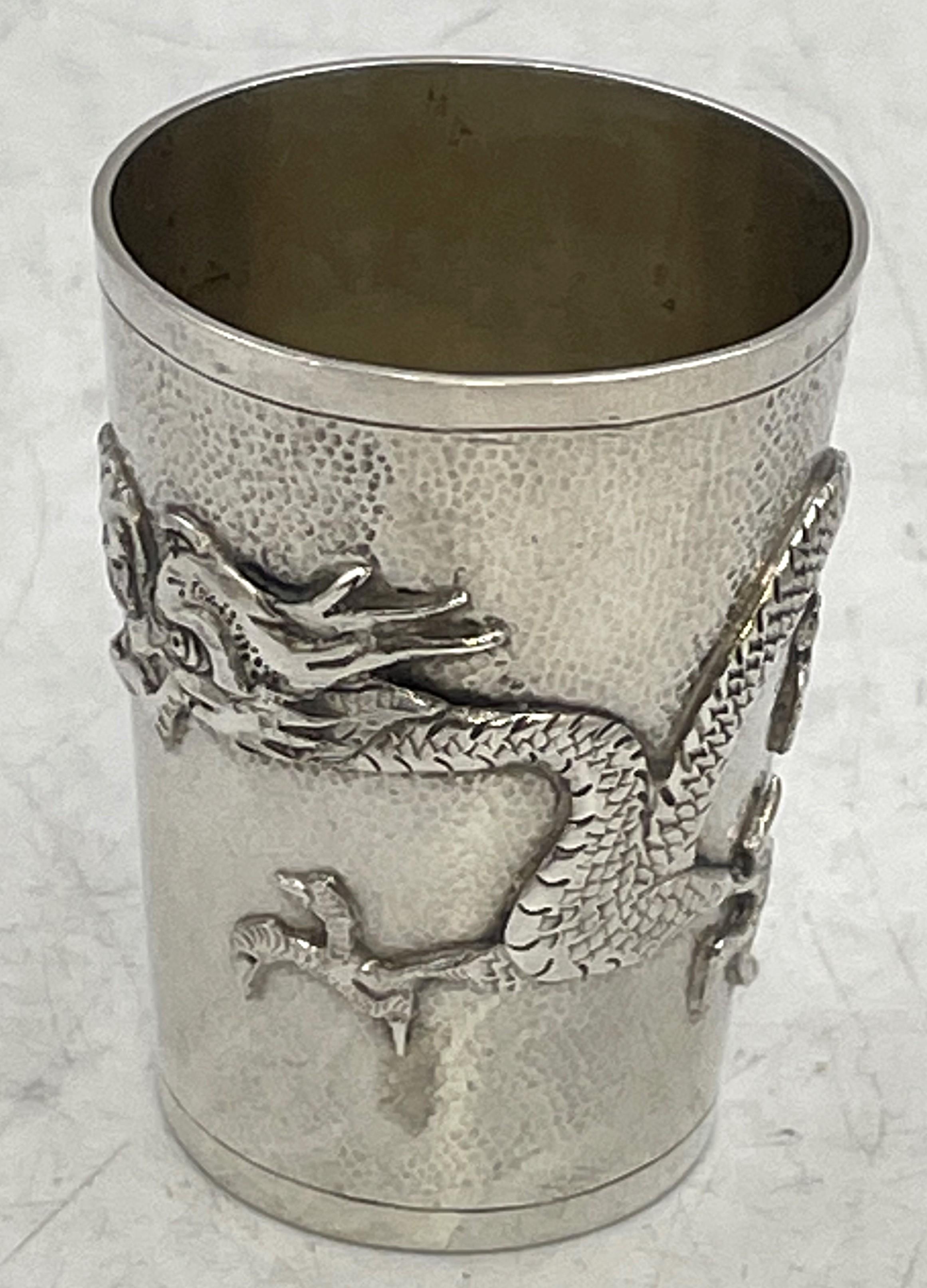 Set of 6 China Jewelry Company silver cups, made in China in the late 19th or early 20th century, beautifully adorned with dragon motifs and an applied cartouche with a monogram. They measure 2'' in height by 1 1/3'' in diameter at the top, weigh